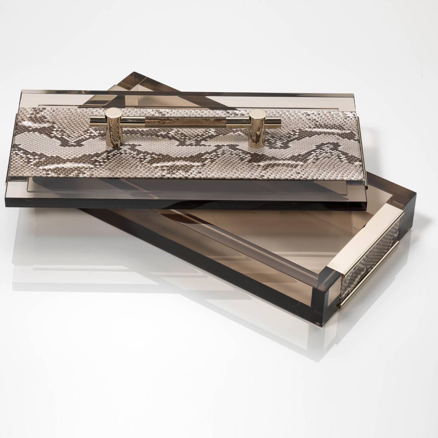 The lid and sides of this exquisite box crafted in translucent Lucite are decorated with natural brown python skin. The leather as well as the handle of the lid are accented in gold metal.