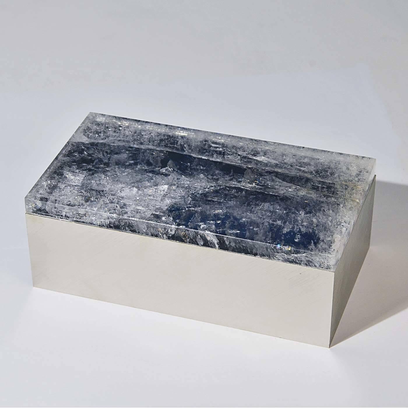 As a gift or part of a personal collection, this exquisite box is a superb addition to any jewelry display. A stately lid in deep blue quartz rests atop a rectangular box fashioned of brushed nickel-plated brass. The smooth texture of the brass and