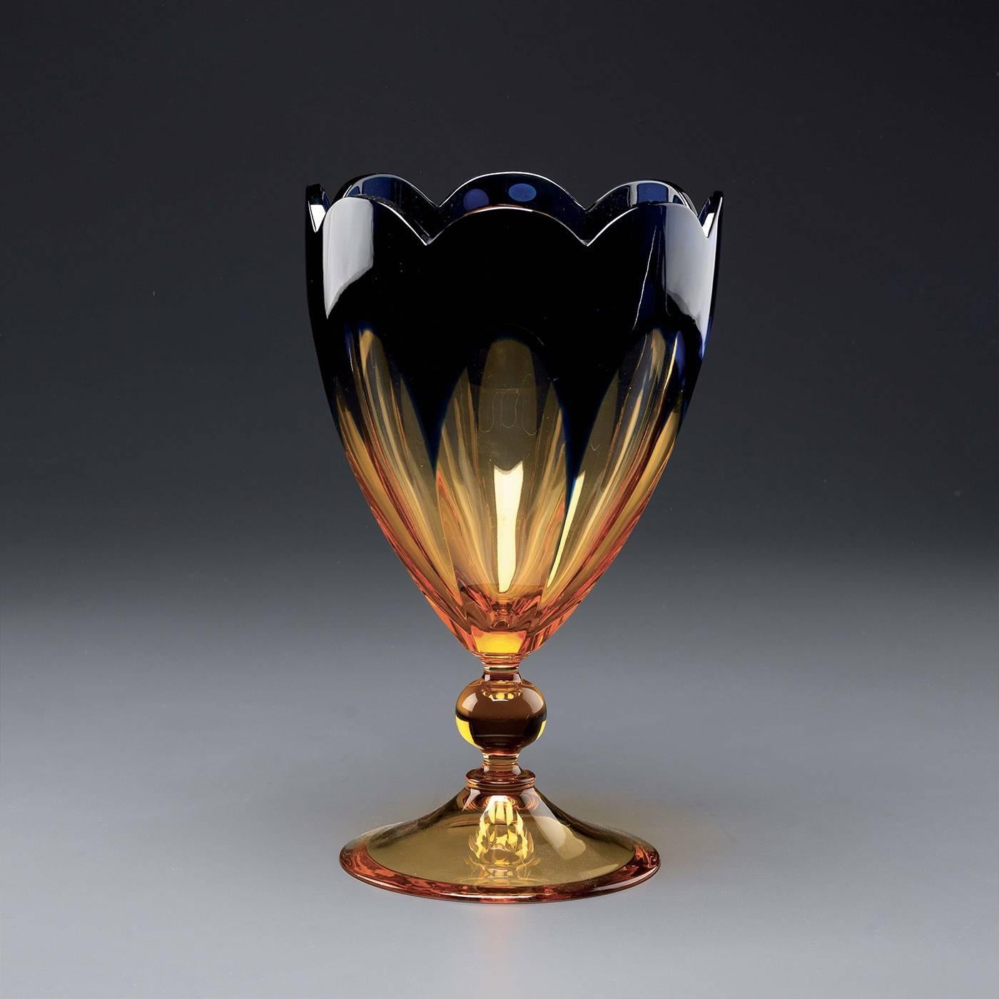 This piece captures the essence of timeless elegance. Entirely handcrafted of blown crystal this vase showcases the craftsmanship of Nuova Cev's master artisans. Layers of pristine clear, blue and amber glass create the incamiciato glass, whose
