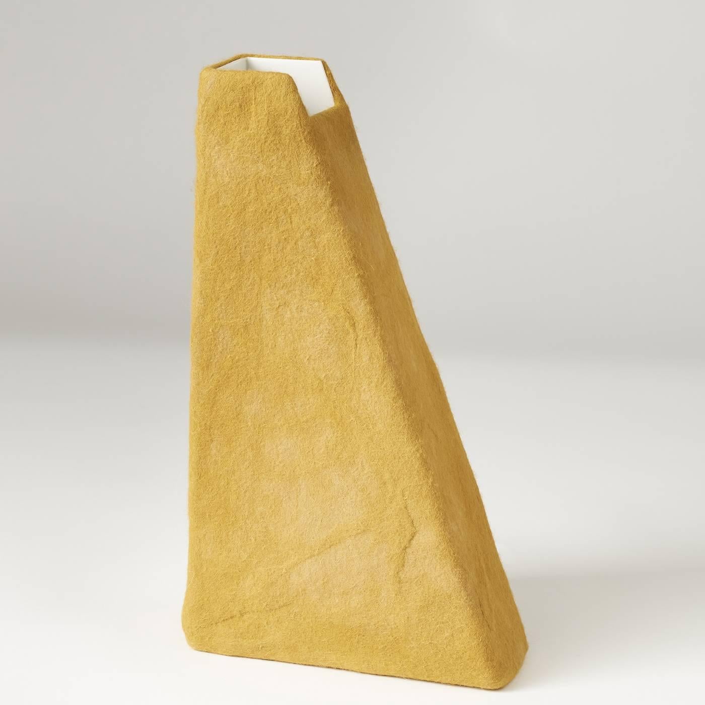 Handmade in Umbria, an unconventional selection of materials come together to form this unique vase. The bold, triangular silhouette, crafted out of stainless steel, tapers to a delicate geometric mouth. The white interior contrasts with the bright
