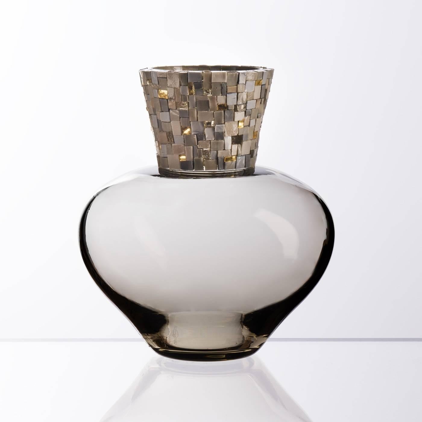 Made of Murano mouth-blown glass in a delicate gray hue, the neck of this polished vase is embellished with a striking mosaic of precious gold foil tesserae with gray opaque and transparent glass for an effect that is stylish without being