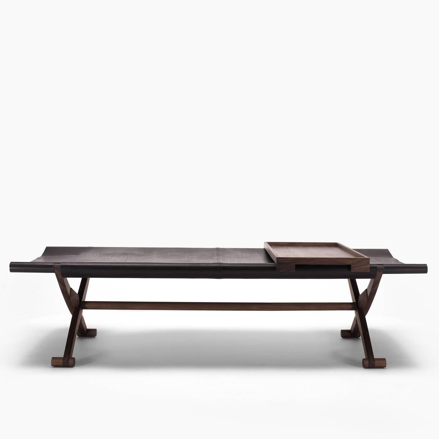 The origins of this product are as old as time, and most likely this was once a travel bed. This bench is made of solid black hickory, with a seat in full-grain leather. Branda can be folded for storage when not in use.