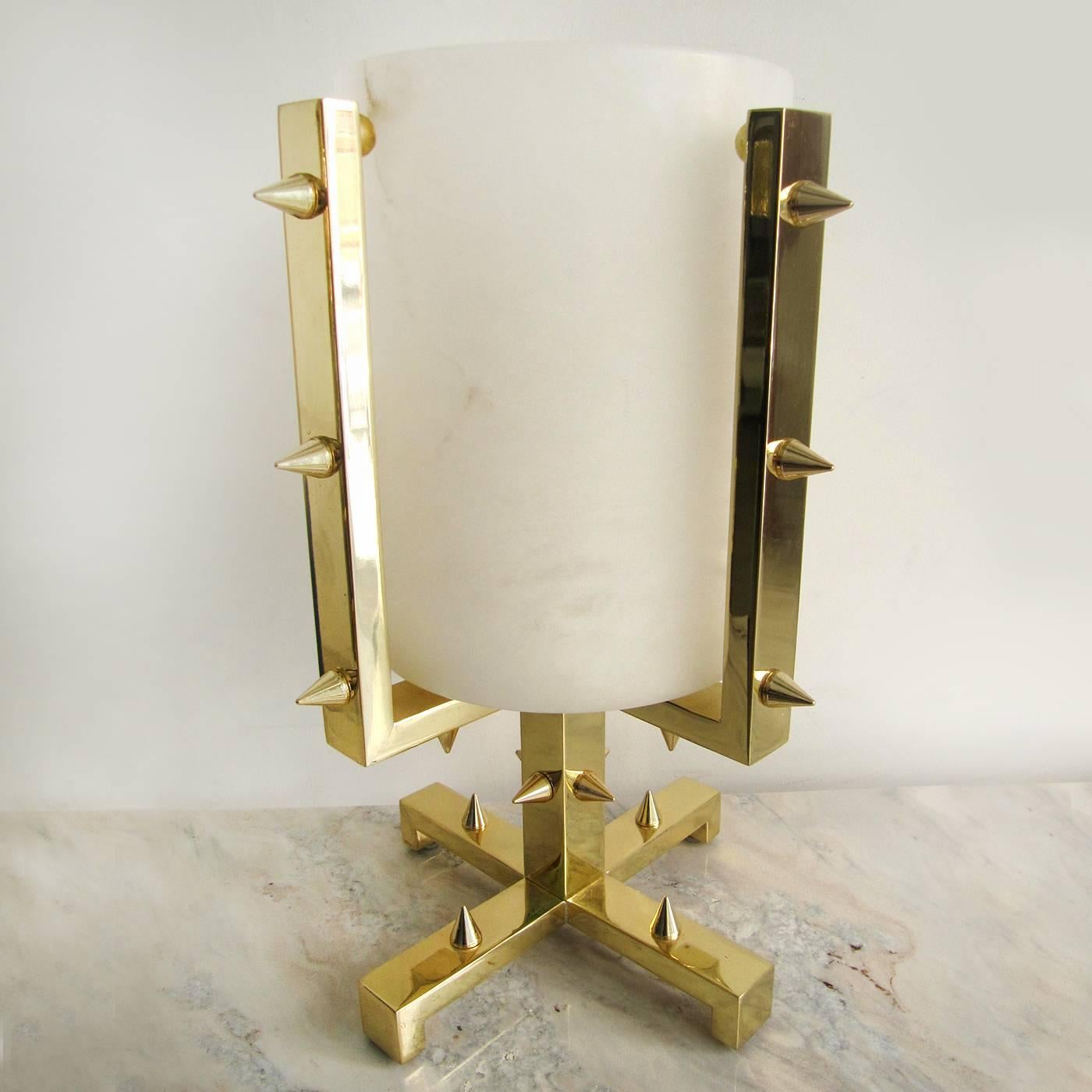 A single piece of alabaster creates this elegant vase enclosed in a structure in brass finished with a protective gloss and decorated with brass spikes. Reminiscent of a Medieval goblet.