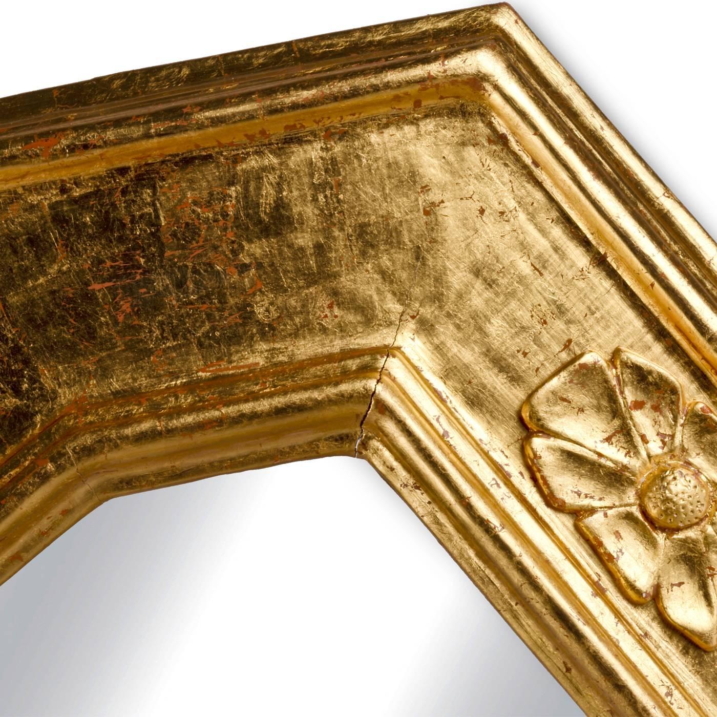 This sophisticated mirror features a design that is classic and elegant and dates back to the 16th century. Traditional methods were used in hand crafting it and the precious addition of pure gold leaf that covers it makes this piece a true objet