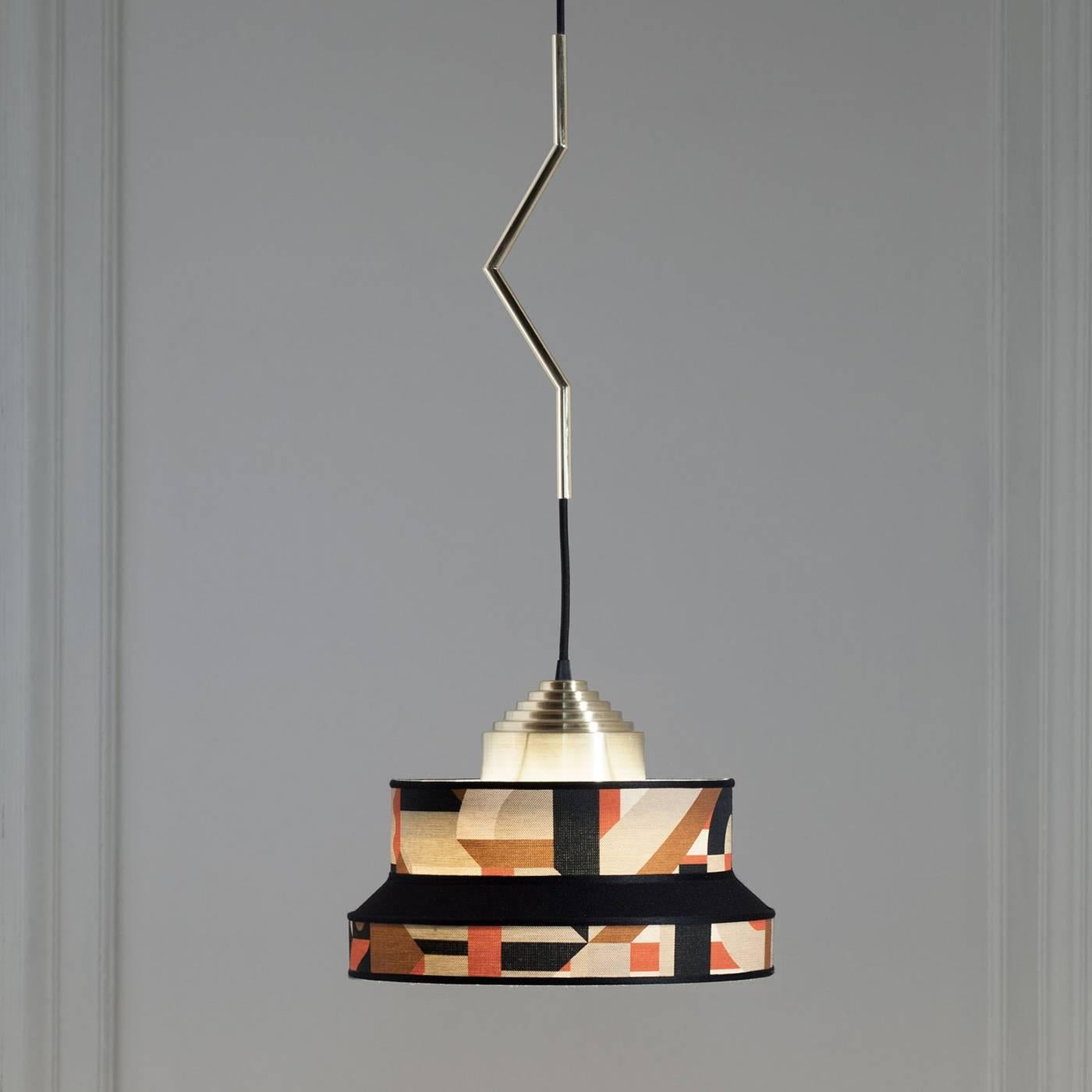 This exquisite pendant lamp reinterprets the lightness and elegance of the 1930s Italian cafes with a brass structure in a warm golden finish and a fabric by Hermés called Perspective Cavaliere Bayadere in a joyful orange and ochre color palette