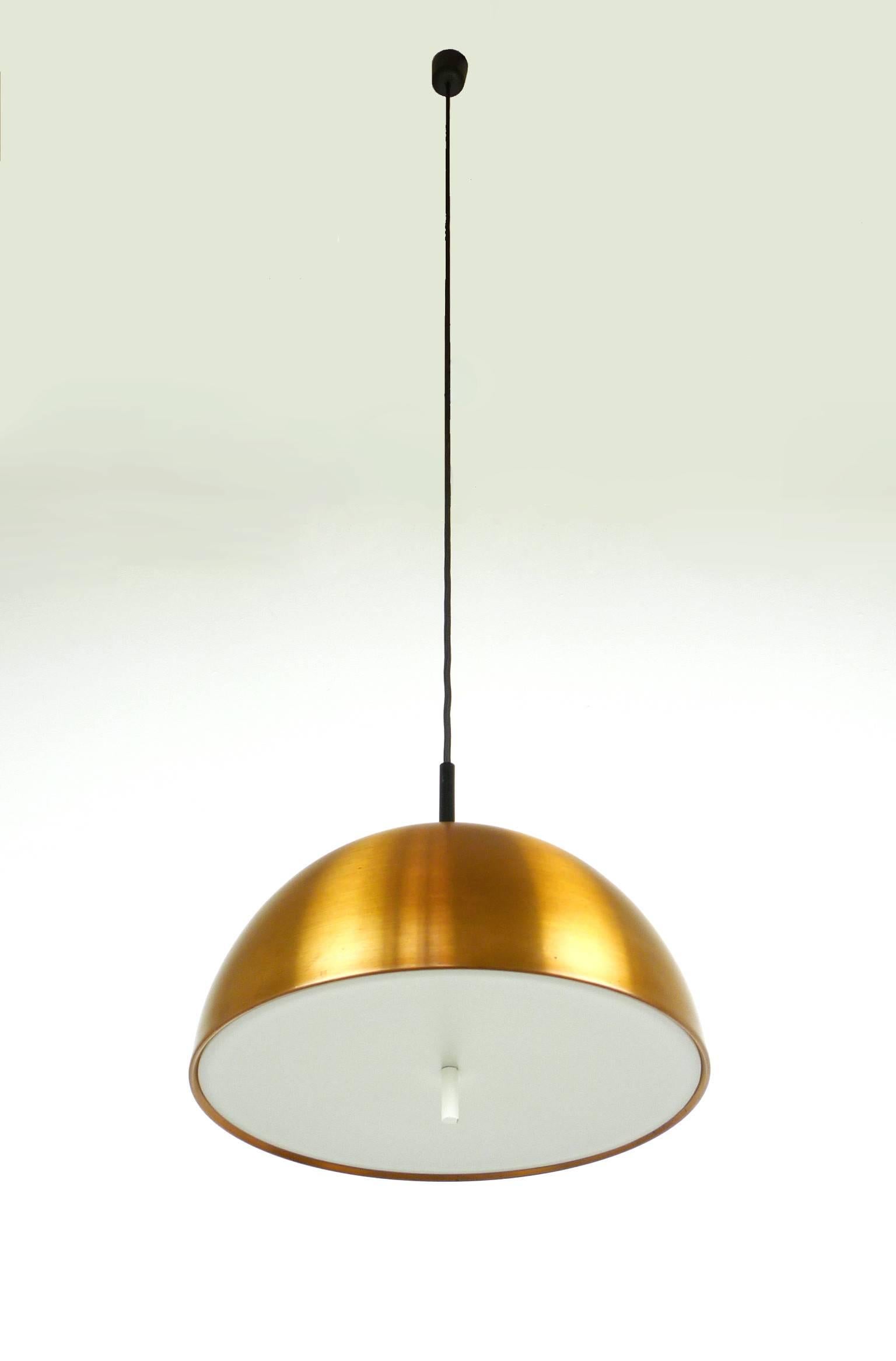 This ceiling lamp was produced by the German manufacturer Staff in the 1960s. It features a round dome made of copper and a white plastic diffuser with two E 27 bulb holders inside. The height of the dome is 20 cm. The electric wire is renewed. The