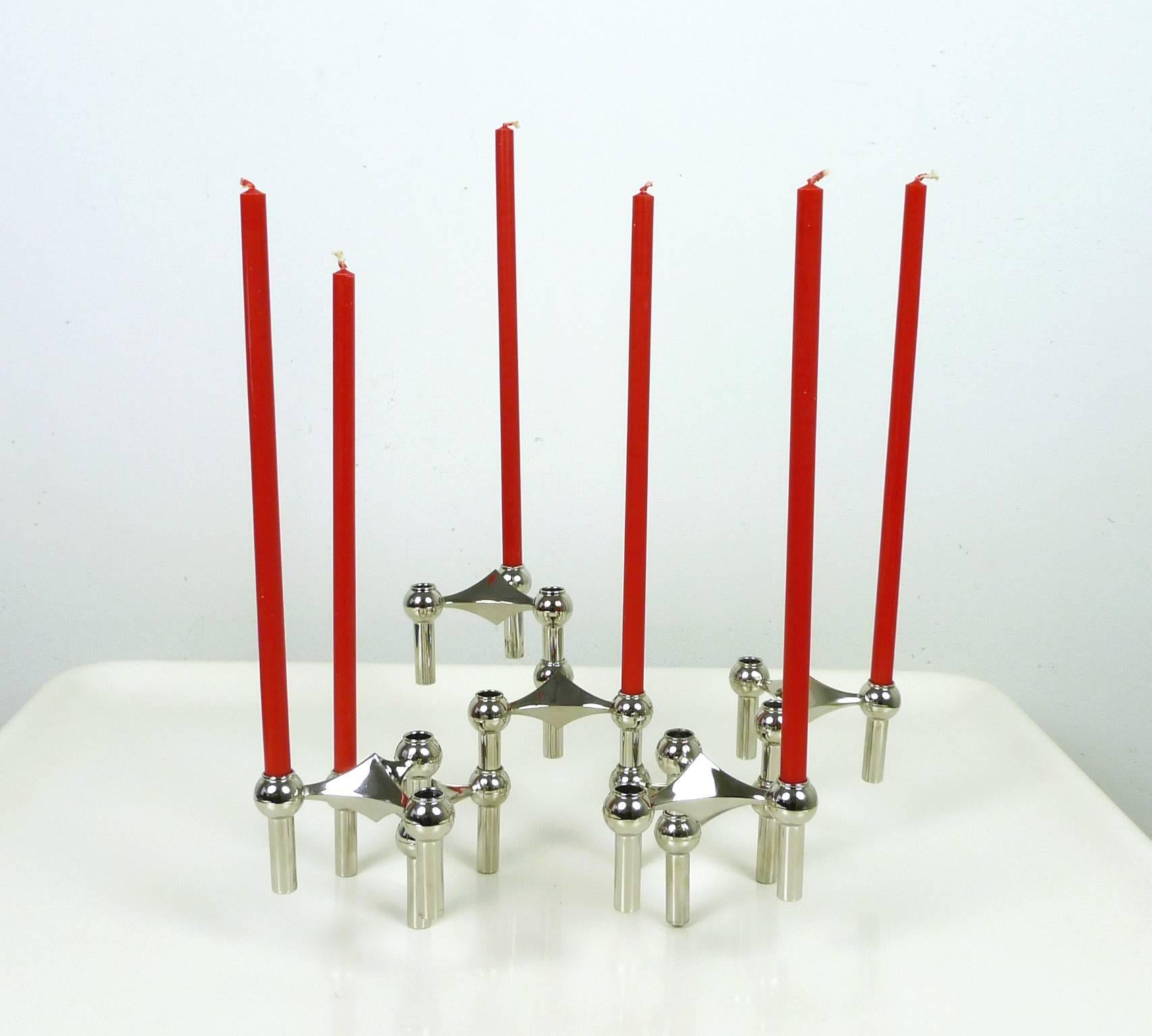 Set of seven chromed metal candleholders model 's 22' with ten matching table candles model 's 10' made of 100 % stearin in original packaging from the German manufacturer Nagel KG. Each candle is 29 cm high.
This modular design can be configured