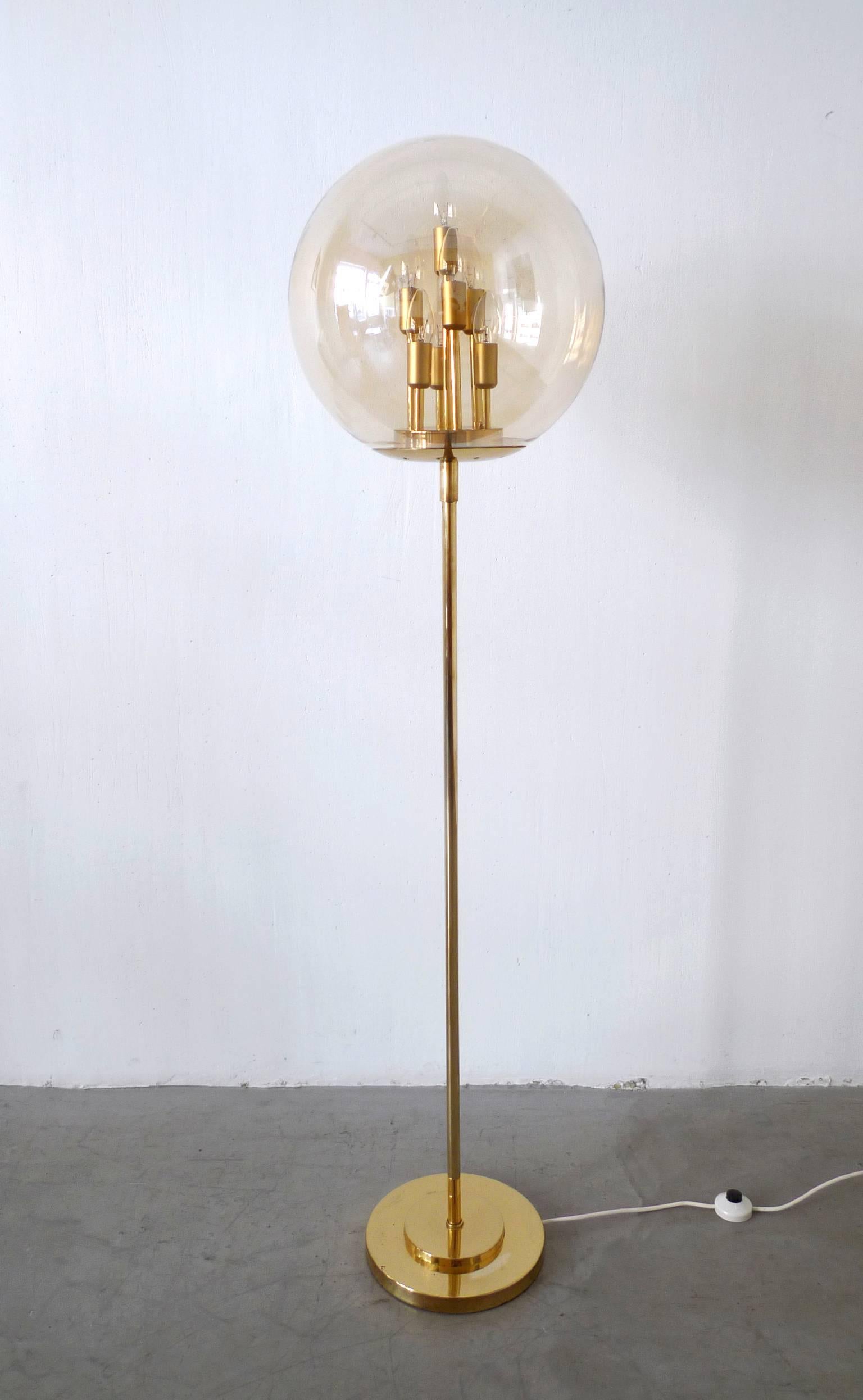 This brass floor lamp with a large tinted glass diffuser holds seven different high lamp holders inside to ensure an interesting and warmly-colored light. The lamp holders are for E 14 bulbs, and the piece remains in a very good original condition.