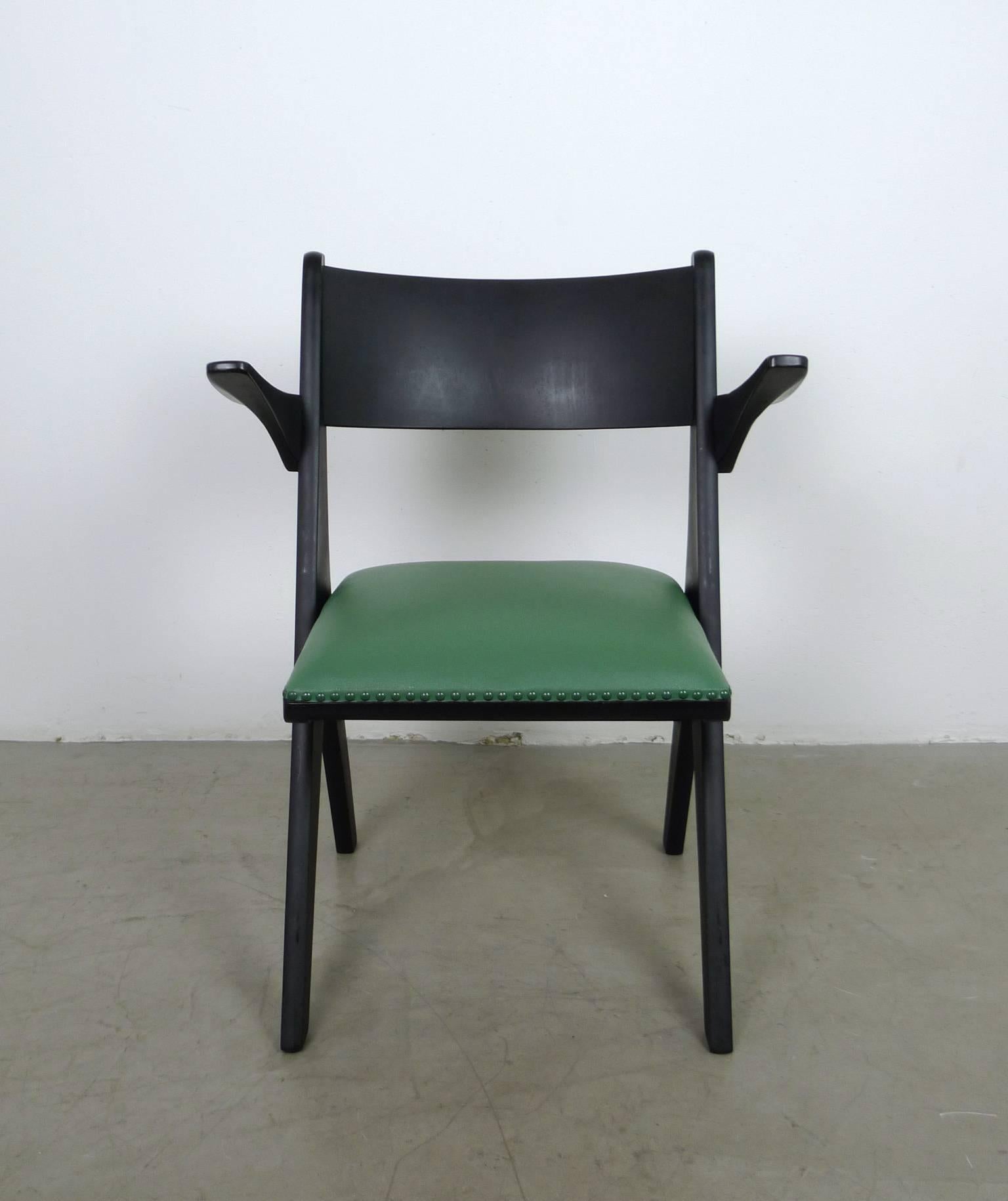 Model penguin armchair from the 1950s designed by Carl Sasse and produced by Casala in Germany.
The black stained beech frame holds a vinyl-covered seat cushion in green, which is fastened with ornamental nails.
This chair is in very good vintage