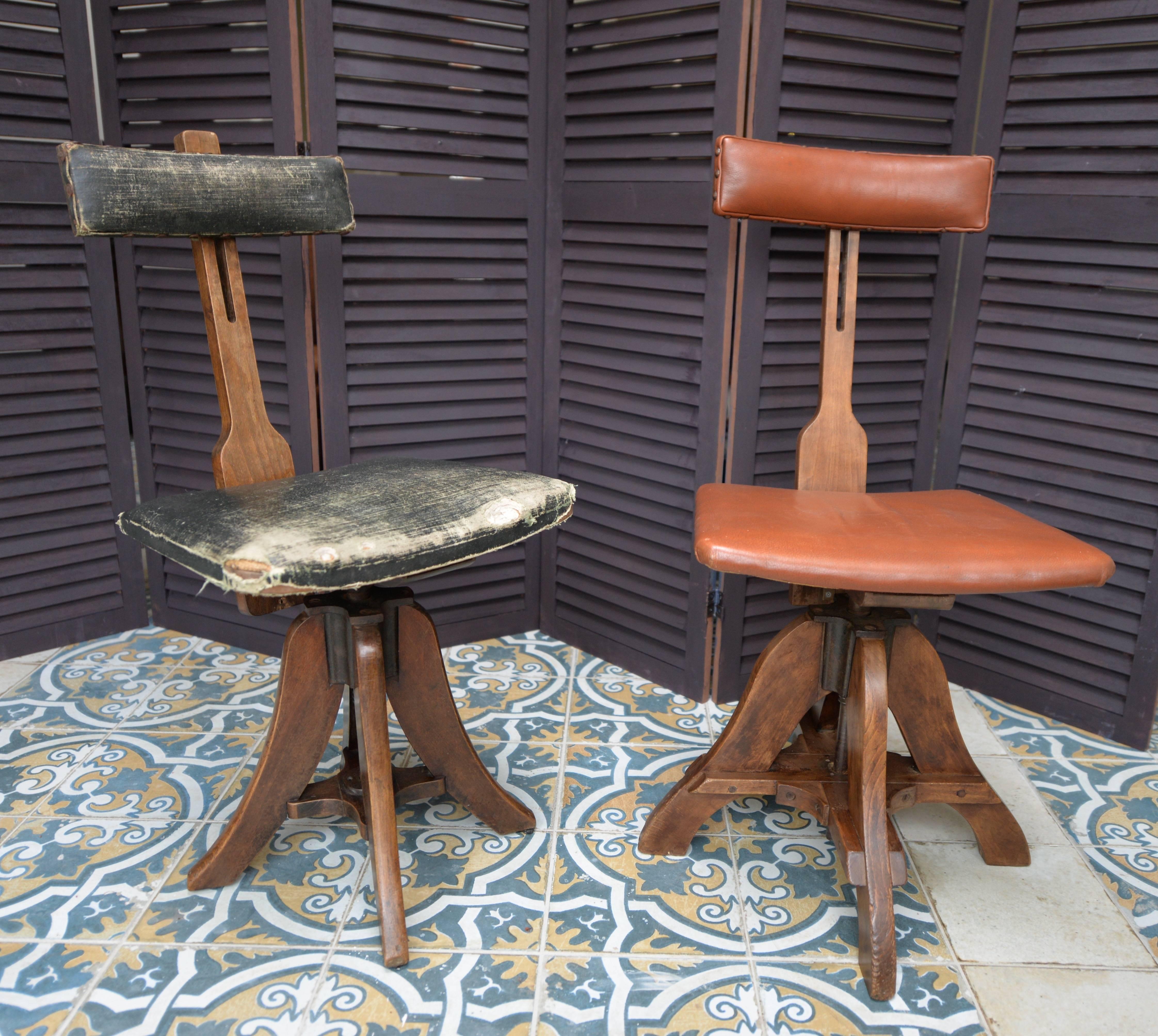 A stylish pair of mahogany framed artist's or draughtsman’s chairs from the late 19th century. Both have an adjustable backrest as well as a swivel adjustable seat. Stamped with 'Glenister High Wycombe' numbered 43 and 44, both chairs are in their