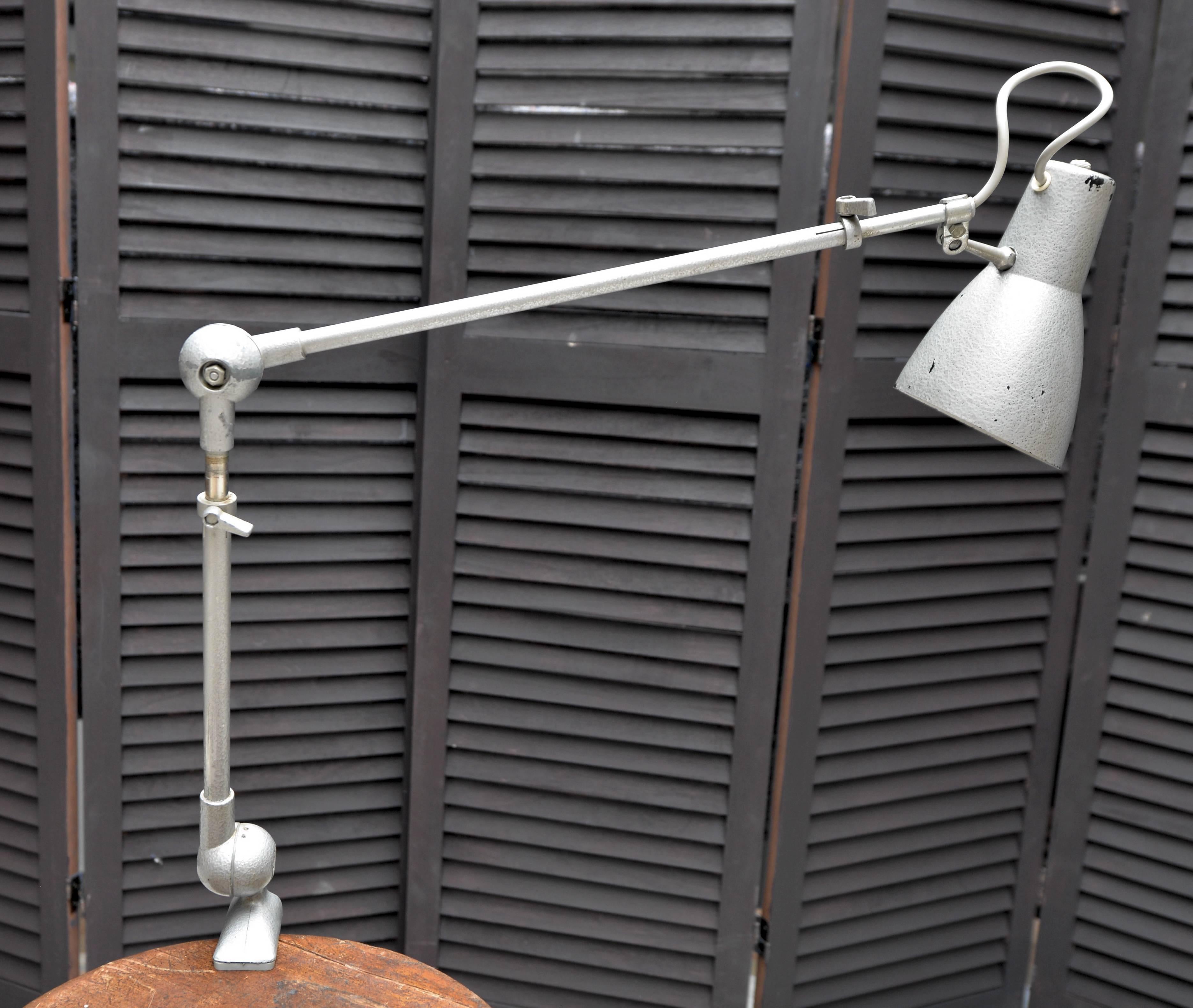 Original French workshop lamp featuring metal structure and plastic reflector.