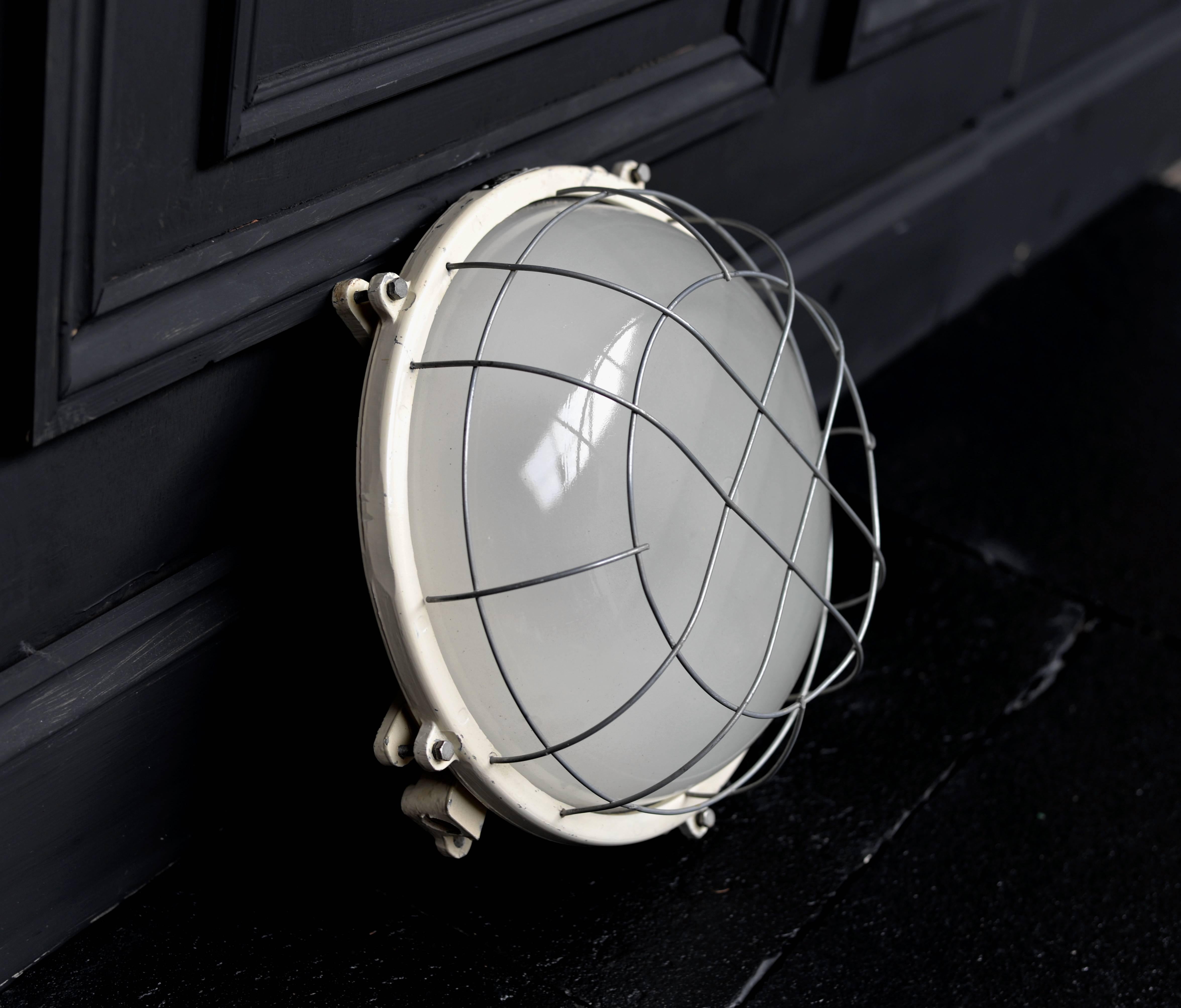 Salvaged Marine/Nautical bulkhead outdoor wall light round.

The light has been restored, polished and rewired.