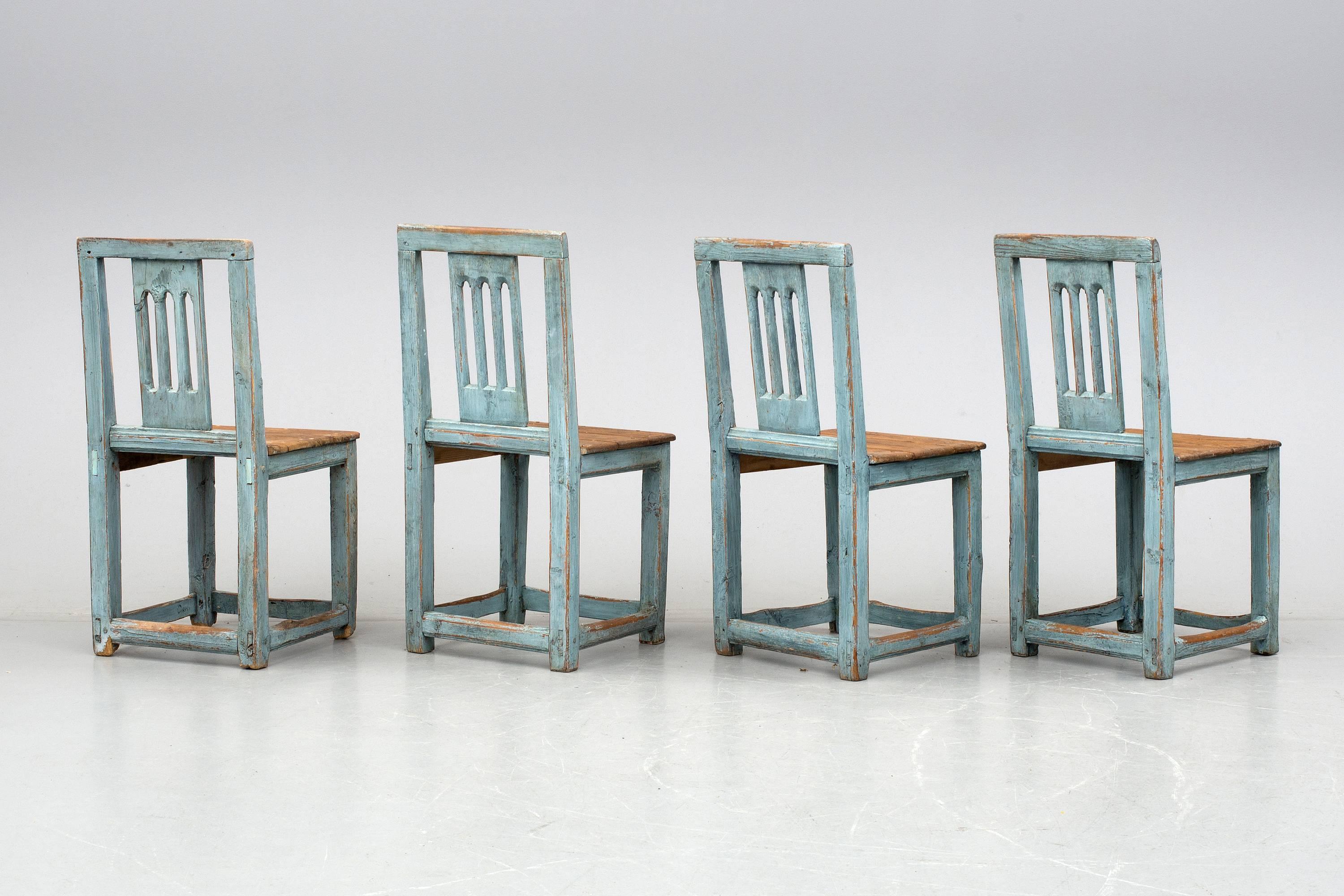 Set of four 18th century Swedish folk chairs from Hälsiagland with old blue patina. One of the chairs has text and sign written under the seat.