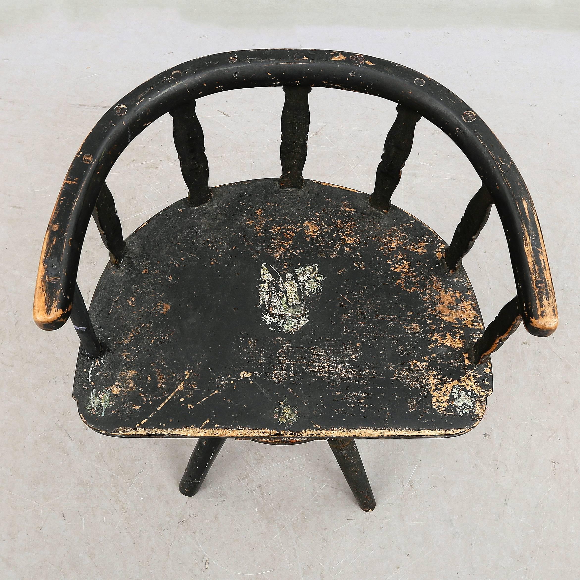 18th century Swedish folk swivel chair with original black paint.