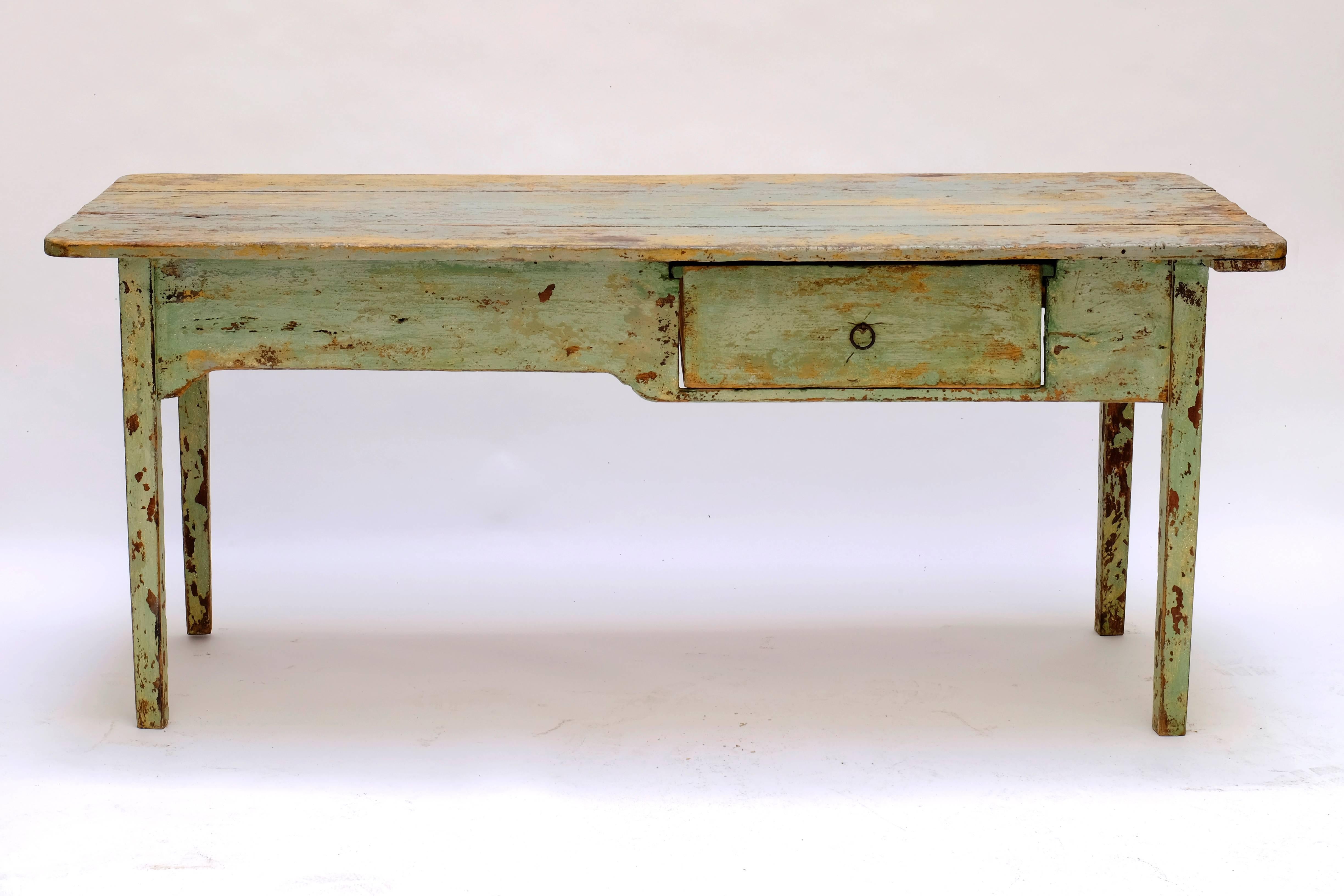 Italian farm table with big drawer, old painted in green and yellow. 
Remains of many layers of paint.
Very strong table.