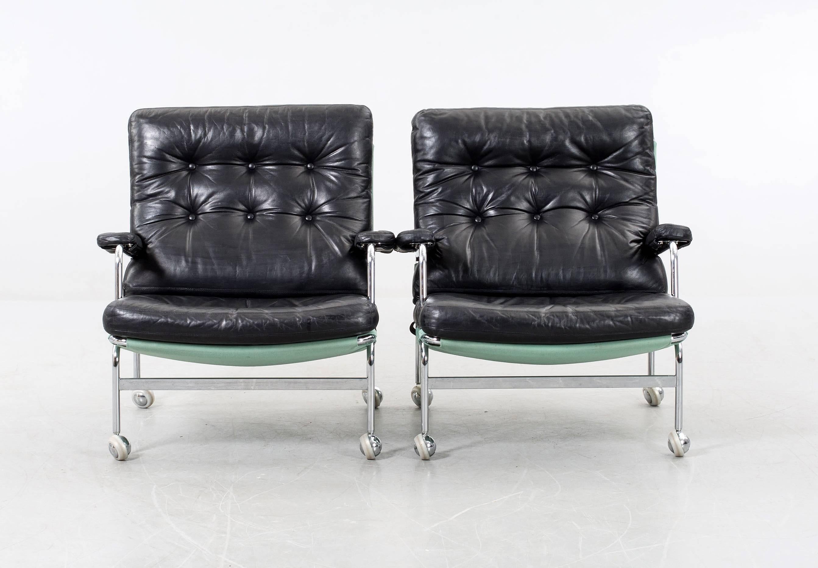 Pair of easy armchairs model Karin designed by Bruno Mathsson. Produced by DUX in Sweden. Frame in chrome steel and black leather upholstered.