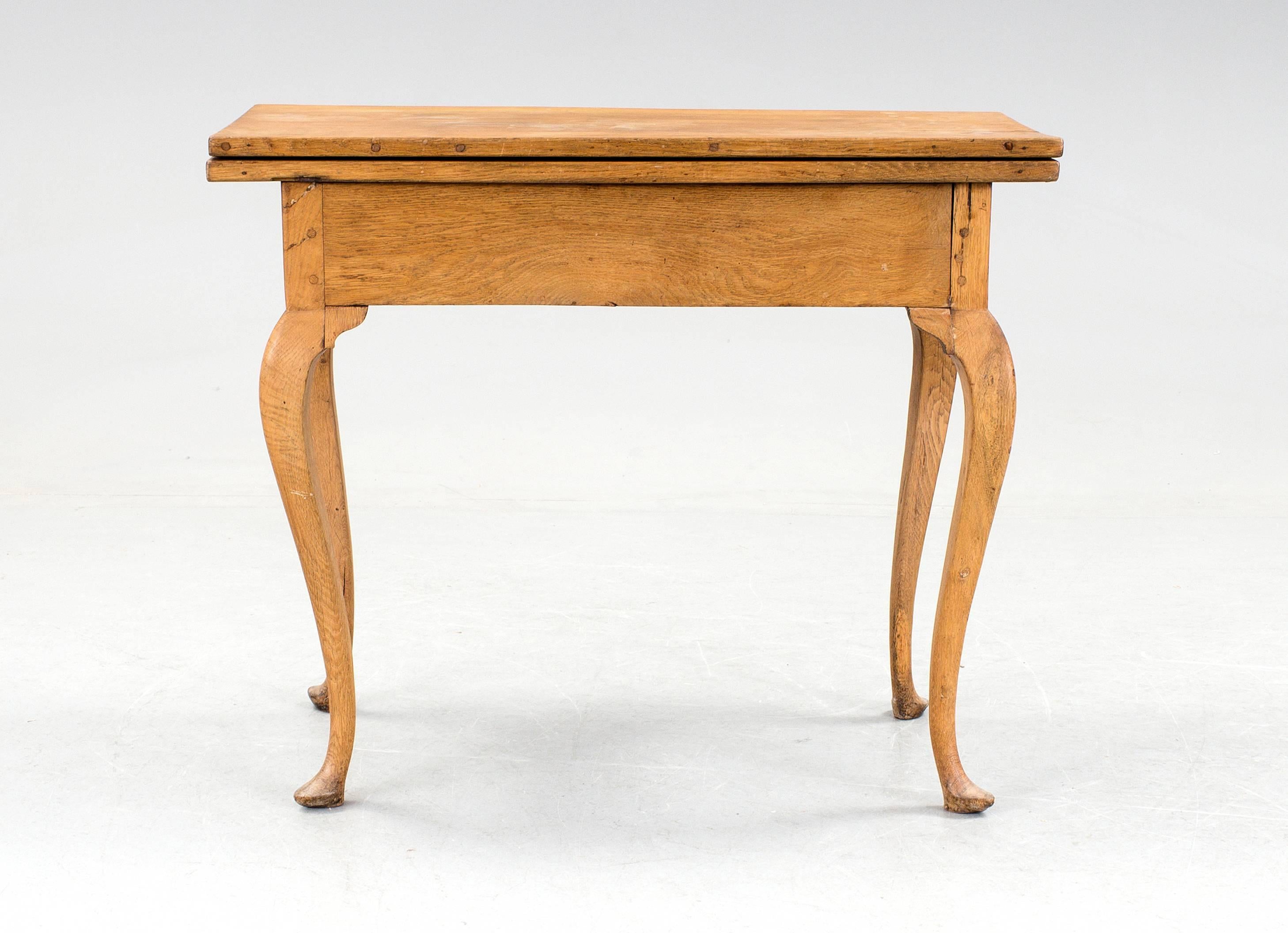 18th century Swedish Rococo game table with folding top, made in oakwood.