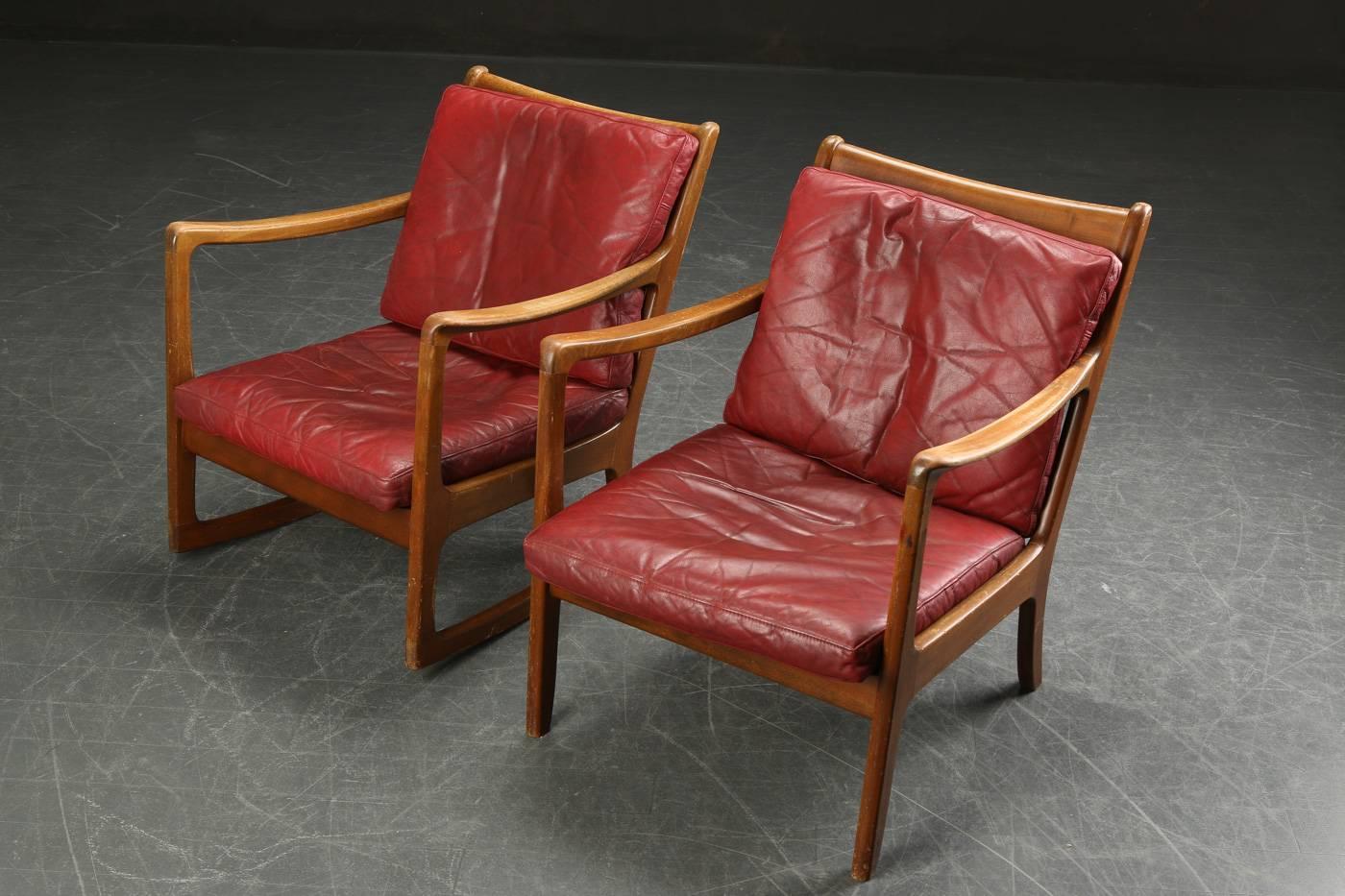 Rare pair of rocking chair and lounge chair designed in mid-20th century by Ole Wanscher. Frames in varnished beech and cushions upholstered in original red leather.