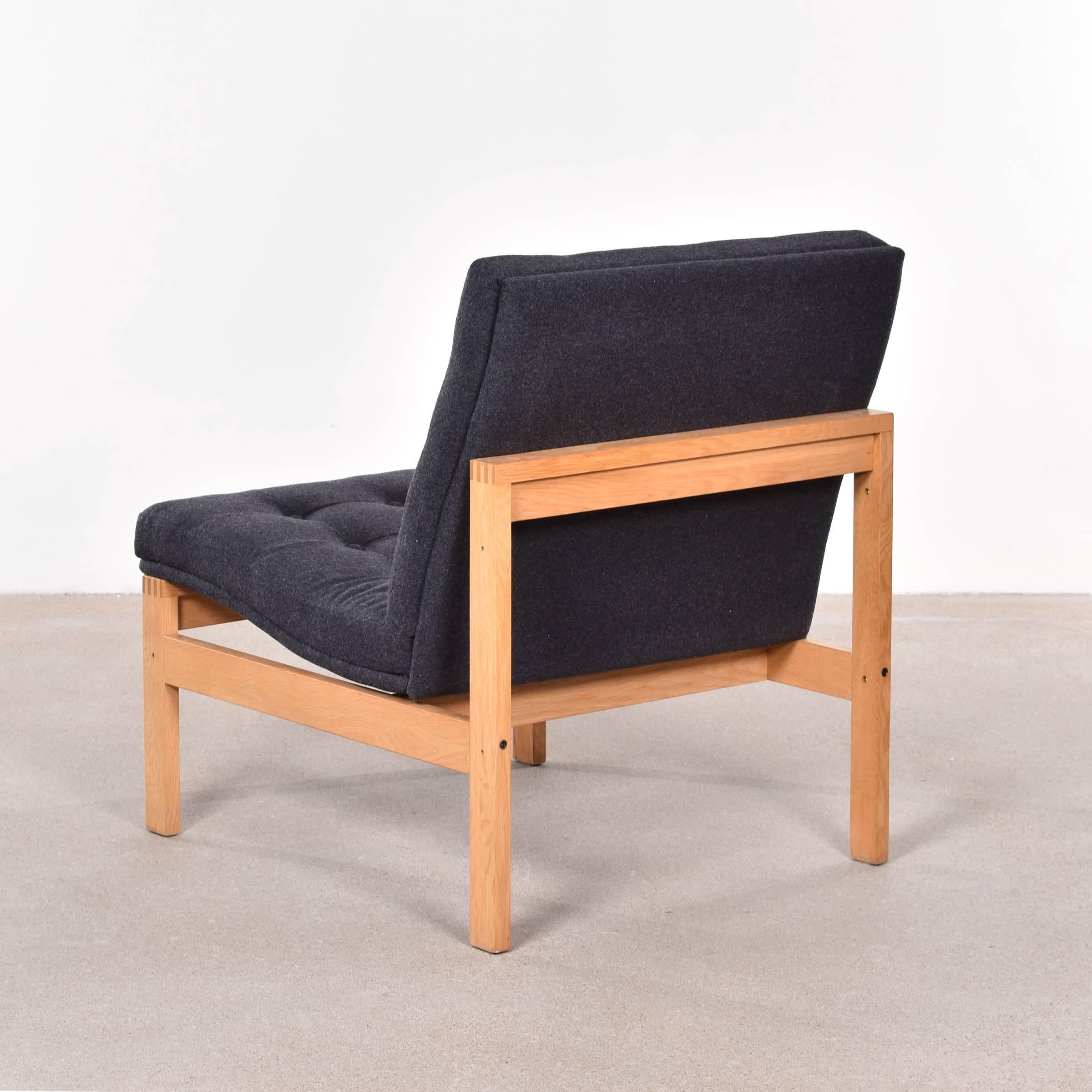 Stylish easy chair by Ole Gjerløv-Knudsen and Torben Lind for France & Son Denmark. Very good condition with oak frame and new dark grey/charcoal wool upholstery. Signed with manufacturer's mark.

Free shipping for European destinations!

We