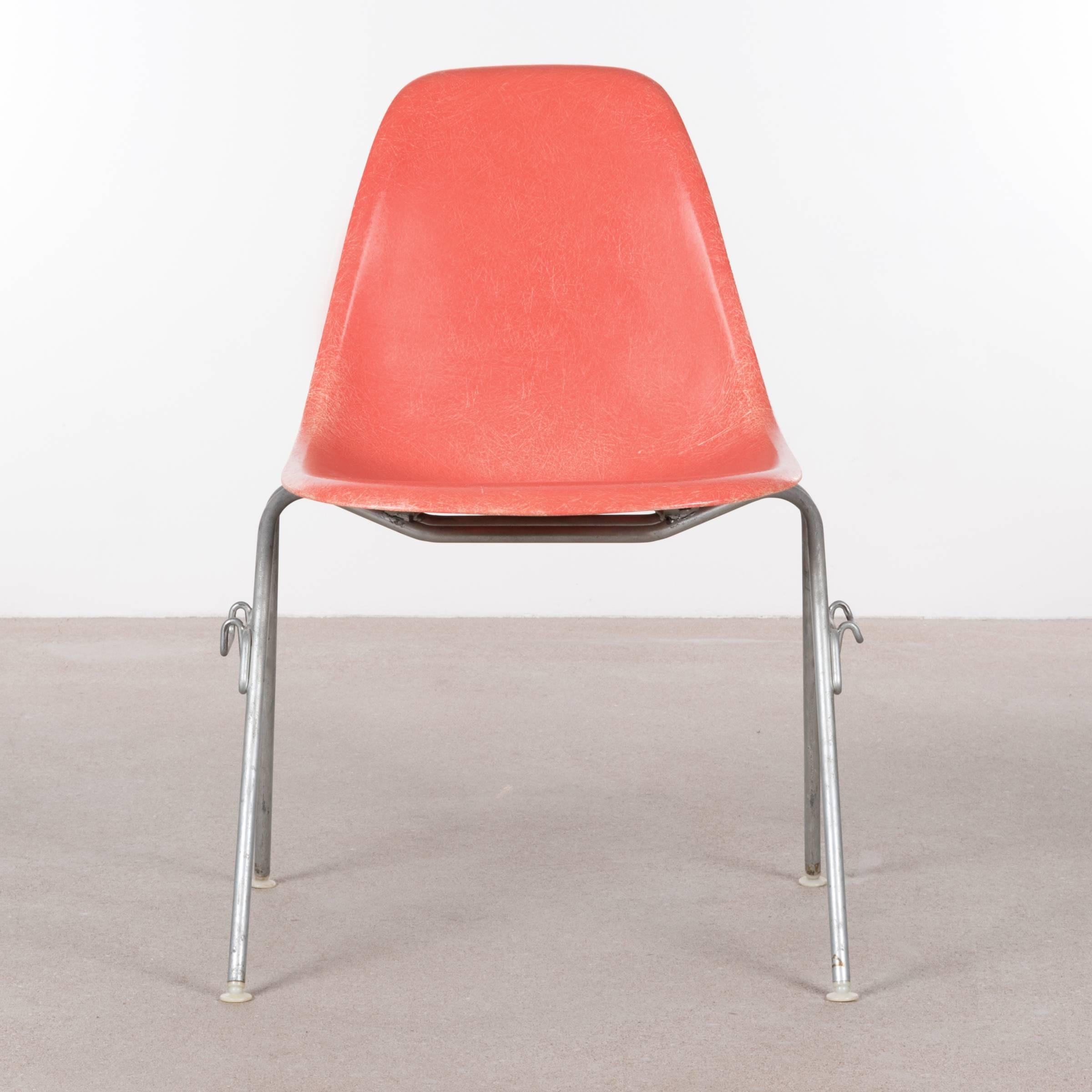 Iconic DSS (D)ining height (S)ide chairs with (S)tacking base in Salmon. The fiberglass shell is in very good vintage condition with only slight traces of use. Original zinc-plated steel base also in very good condition. The chairs are signed patent
