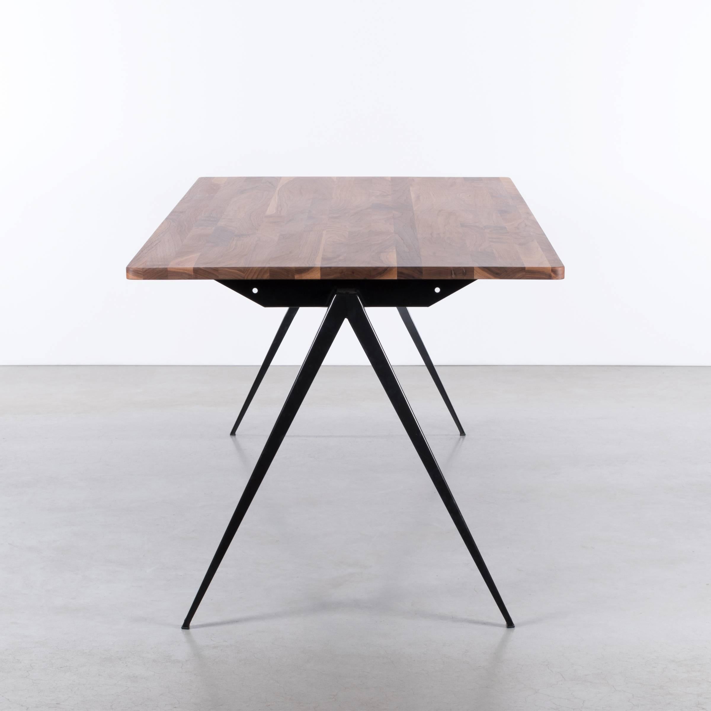 Great Industrial and beautiful dining table by Galvanitas. Black powder coated steel frame with compass legs and an oiled solid American walnut top. 
Bespoke options available if desired. The table can ship flat for more efficiency.