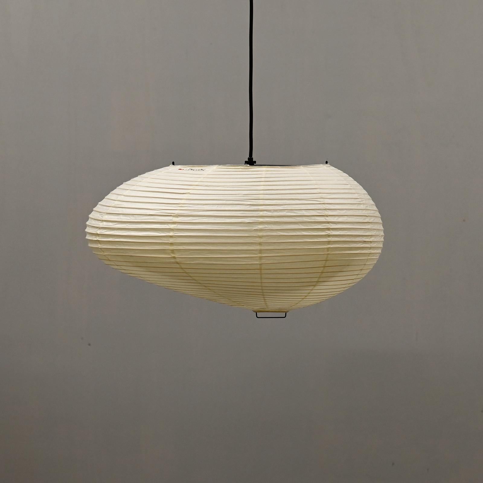 Iconic Akari light sculpture known as Model 16A designed by Isamu Noguchi and handcrafted from traditional washi paper and bamboo. Each Akari lamp shade is meticulously crafted by hand in the Ozeki workshop, a traditional family-owned company, based