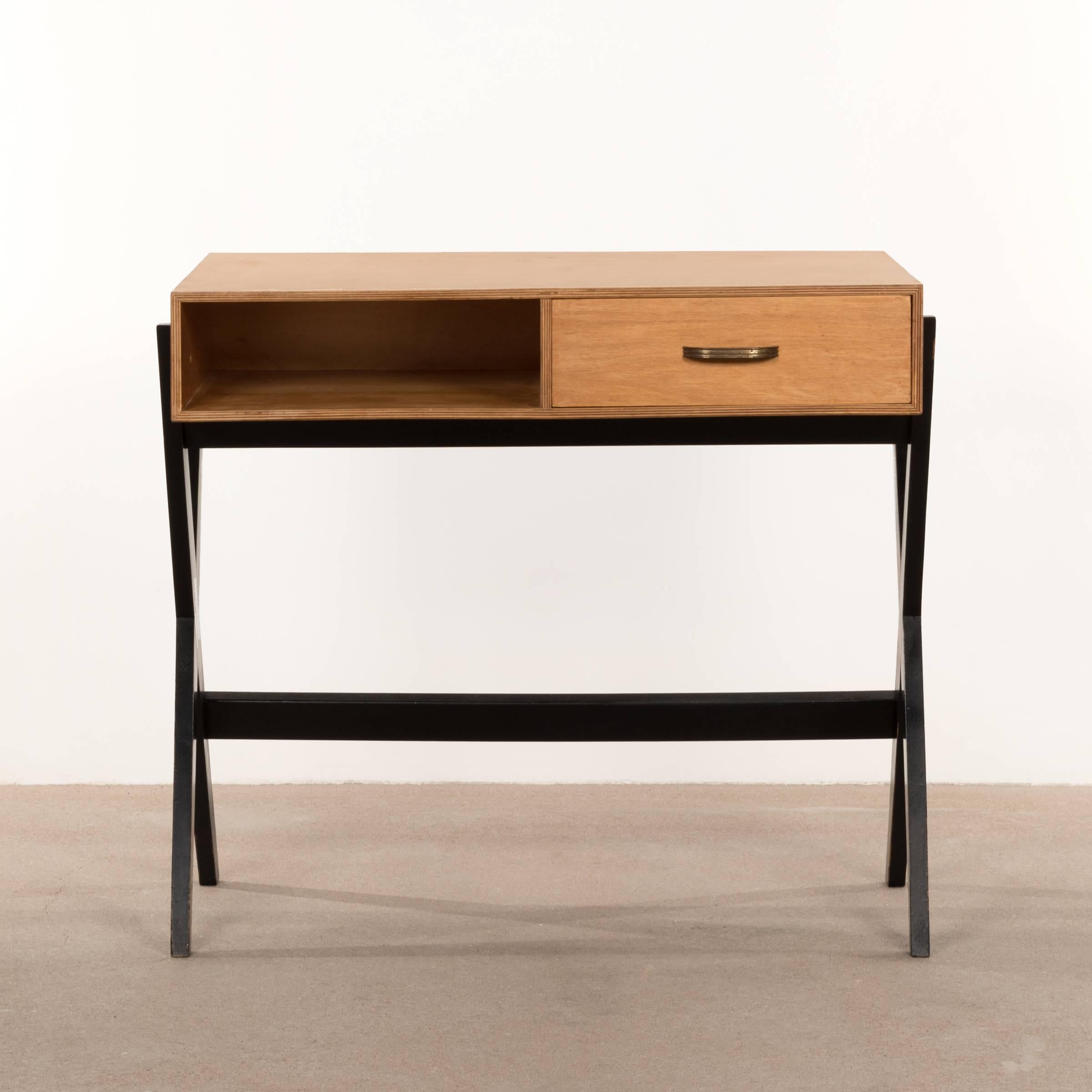 Elegant small Industrial birchwood desk by Coen de Vries in 1954. Ebonized X-base frame, single drawer and birch plywood top. Good condition with small traces of use.