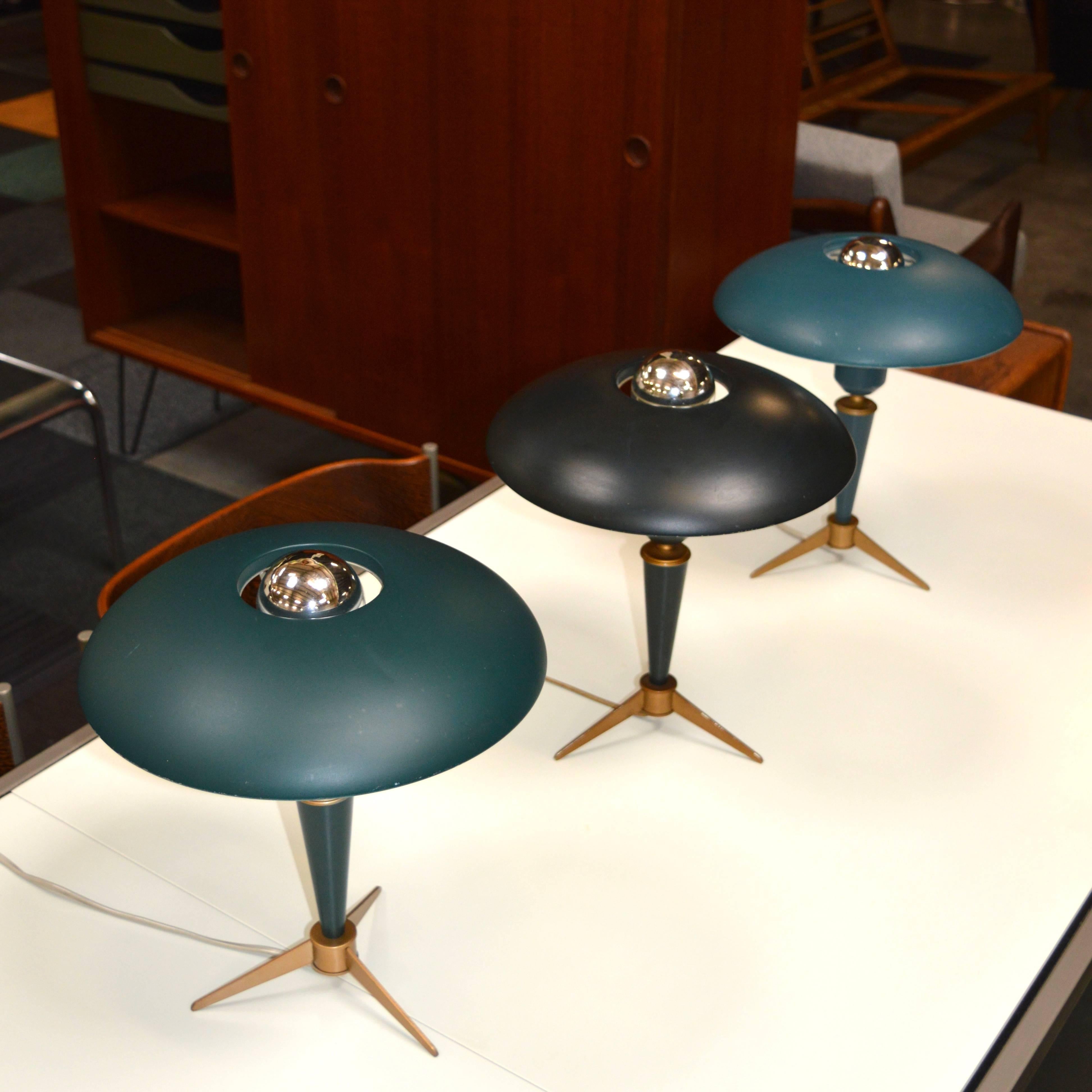 This model was designed for the World Exhibition in Brussels in 1958.
The three lamps have three different color tones. 
Overall in very good original condition.
One lamp has some wear to the lacquer along a part of the edge of the hood and some