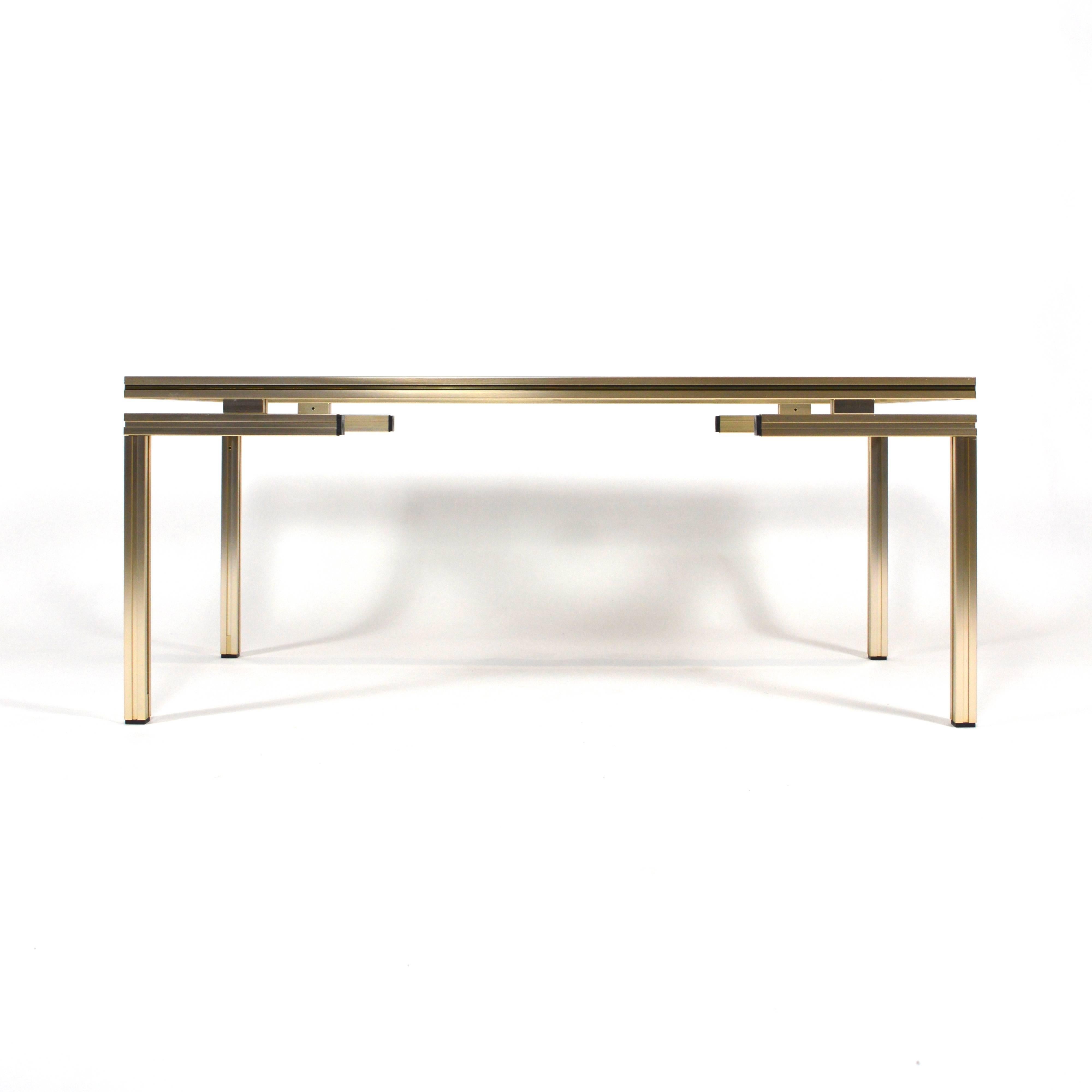 Beautiful French coffee table designed by Pierre Vandel.
Silver and gold colored aluminum base with cut-glass top.
In very good condition but with a 2 inch scratching on one side (see picture).
Vandel was based in Paris and in the 1970s he also