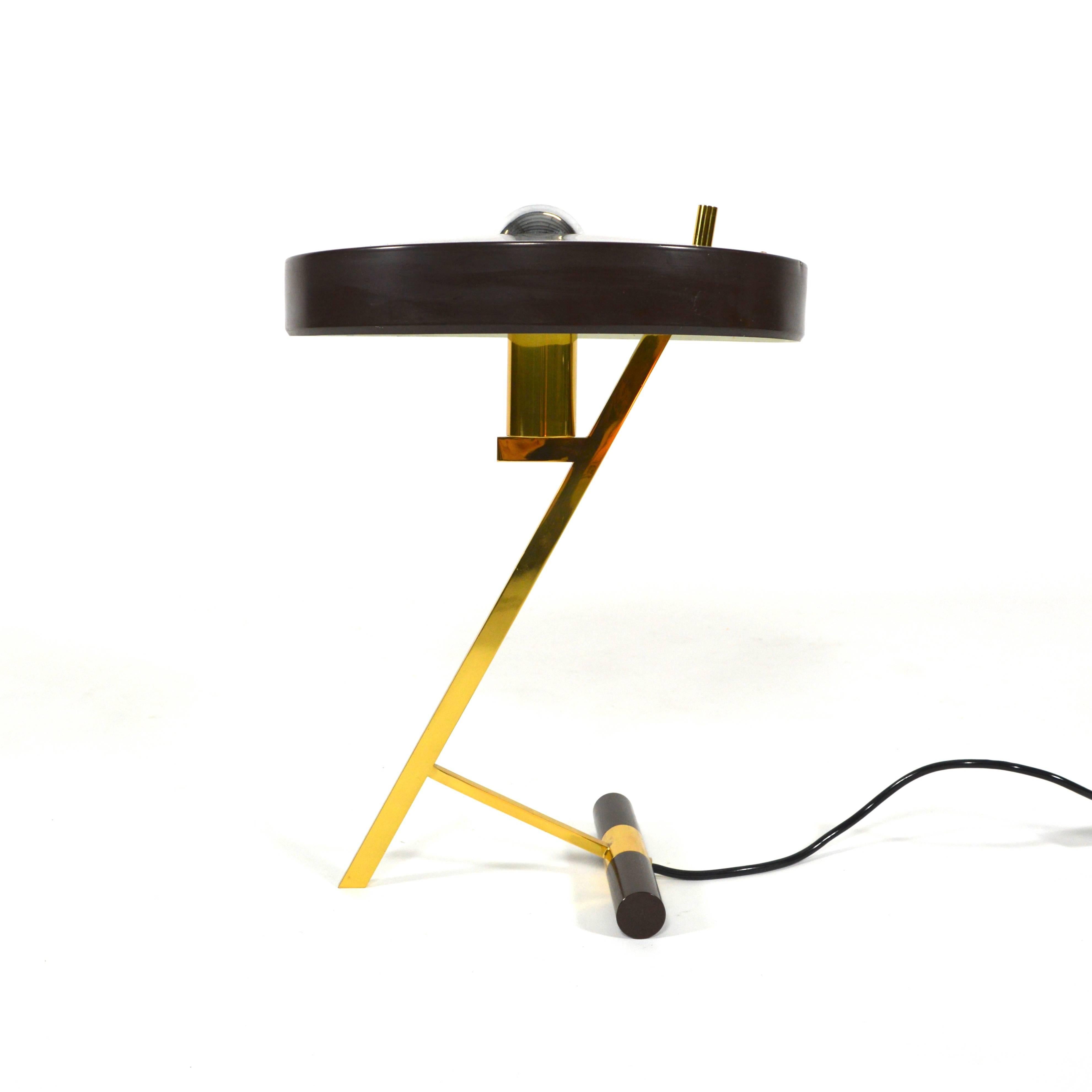 Z-shaped brass desk lamp by Louis Christiaan Kalff.
This lamp is finished in a beautiful dark brown which is more rare then the black edition.
In excellent condition. Some minor wear on the edge of the hood (see picture). 
Do not hesitate to