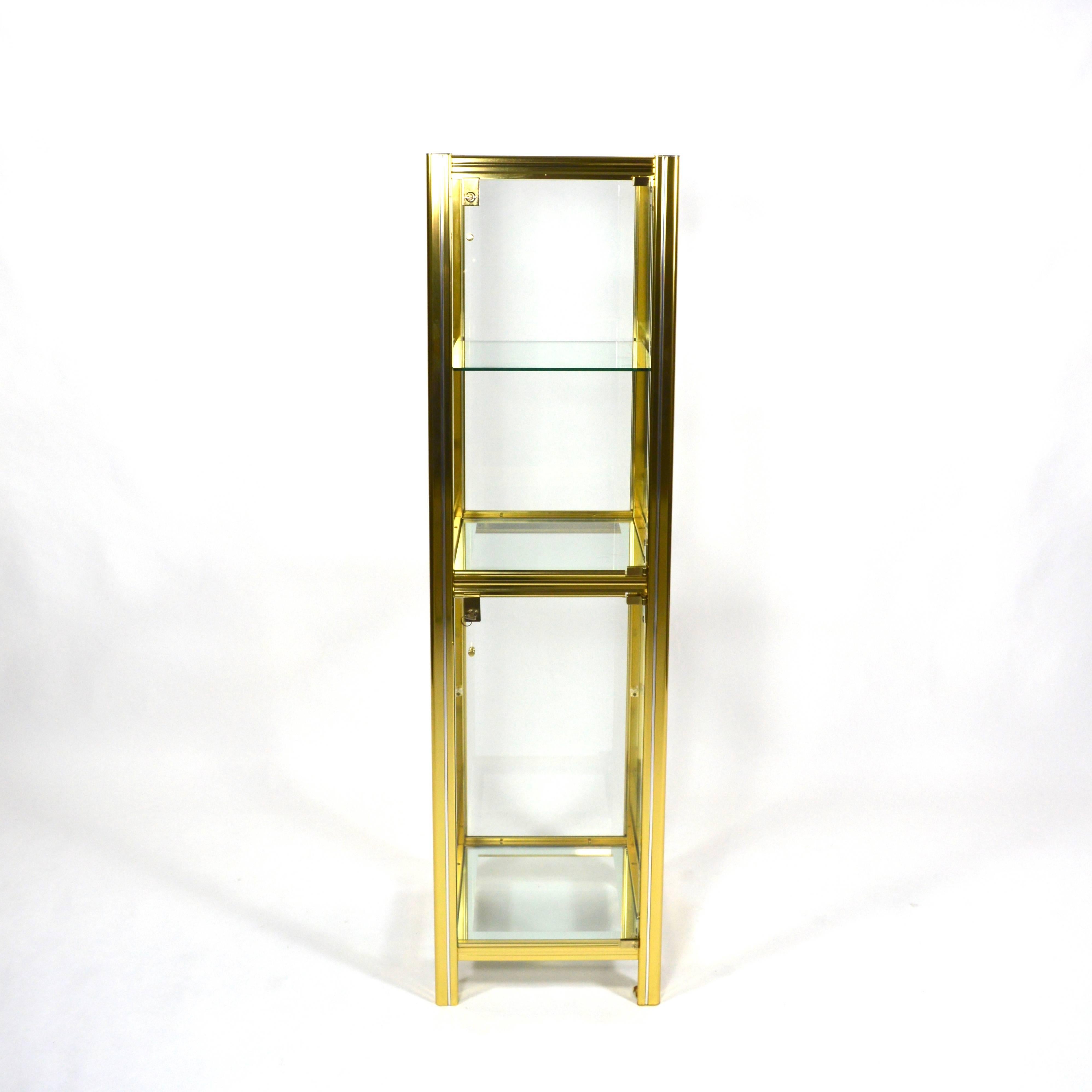 Beautiful Italian showcase made of brass with chrome details.
This vitrine has two doors that can be locked separate.
In excellent condition but the lower glass shelve is replaced by a new one (this glass shelve is not shown in the