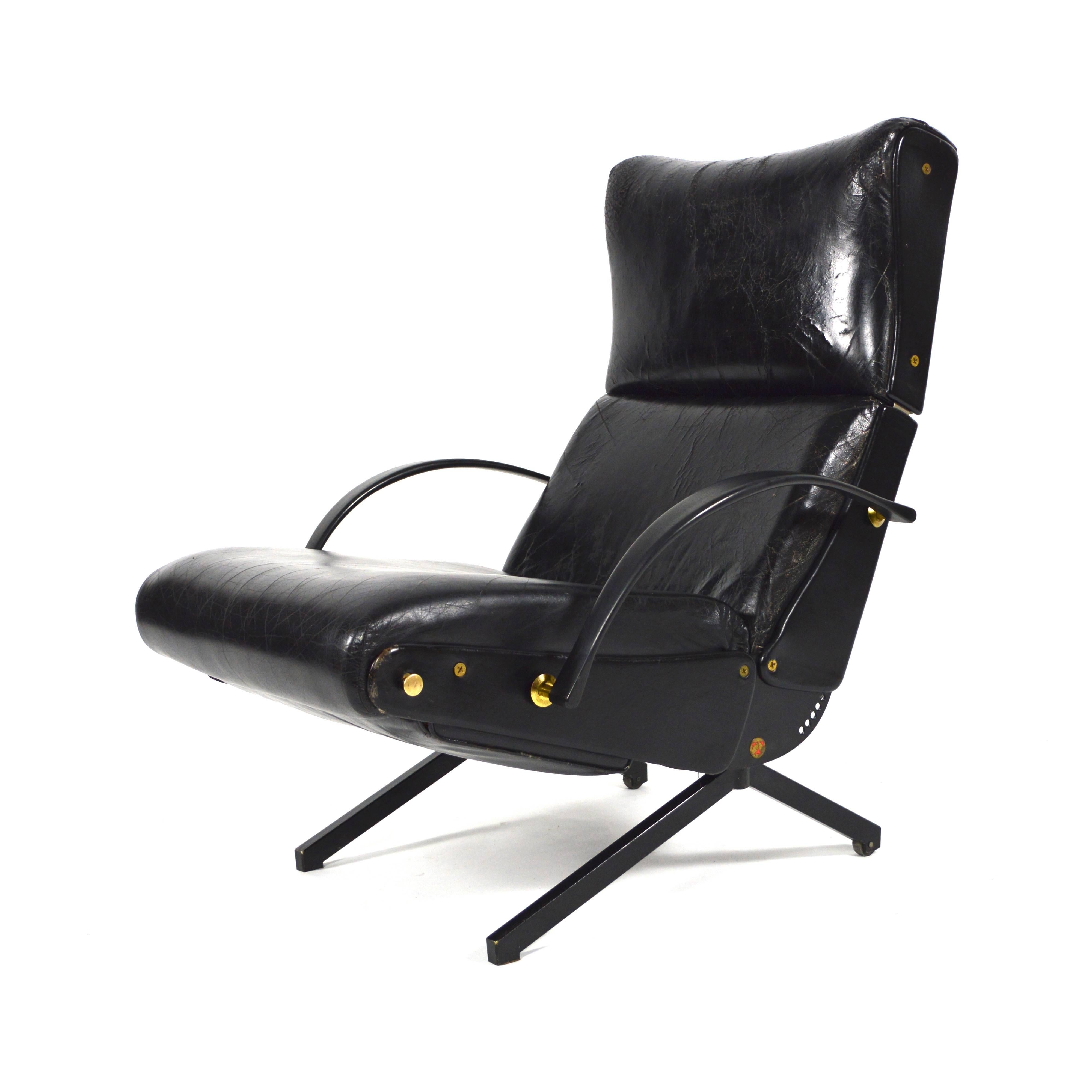 Early edition P40 reclining chair by Osvaldo Borsani.
Black leather with brass details.
The rear legs have wheels.
The leather is distressed on the front side of the backrest, but no tears or holes.
 