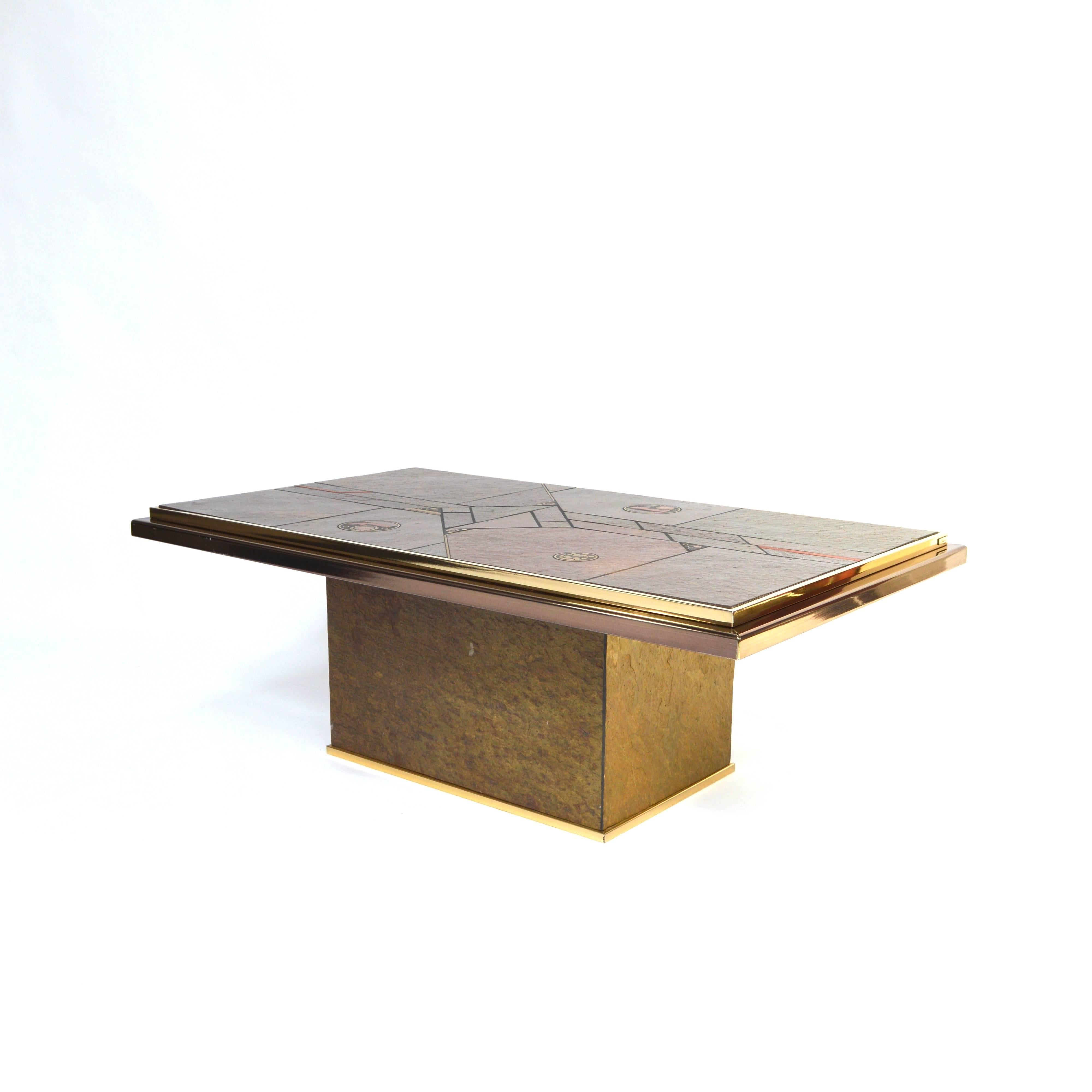 Brutalist coffee table in the style of Paul Kingma and manufactured by Fedam. It has a beautiful stone and brass mosaic top and brass edges. The sides of the base are also covered with stone.
The condition is good to excellent. Small damage to the