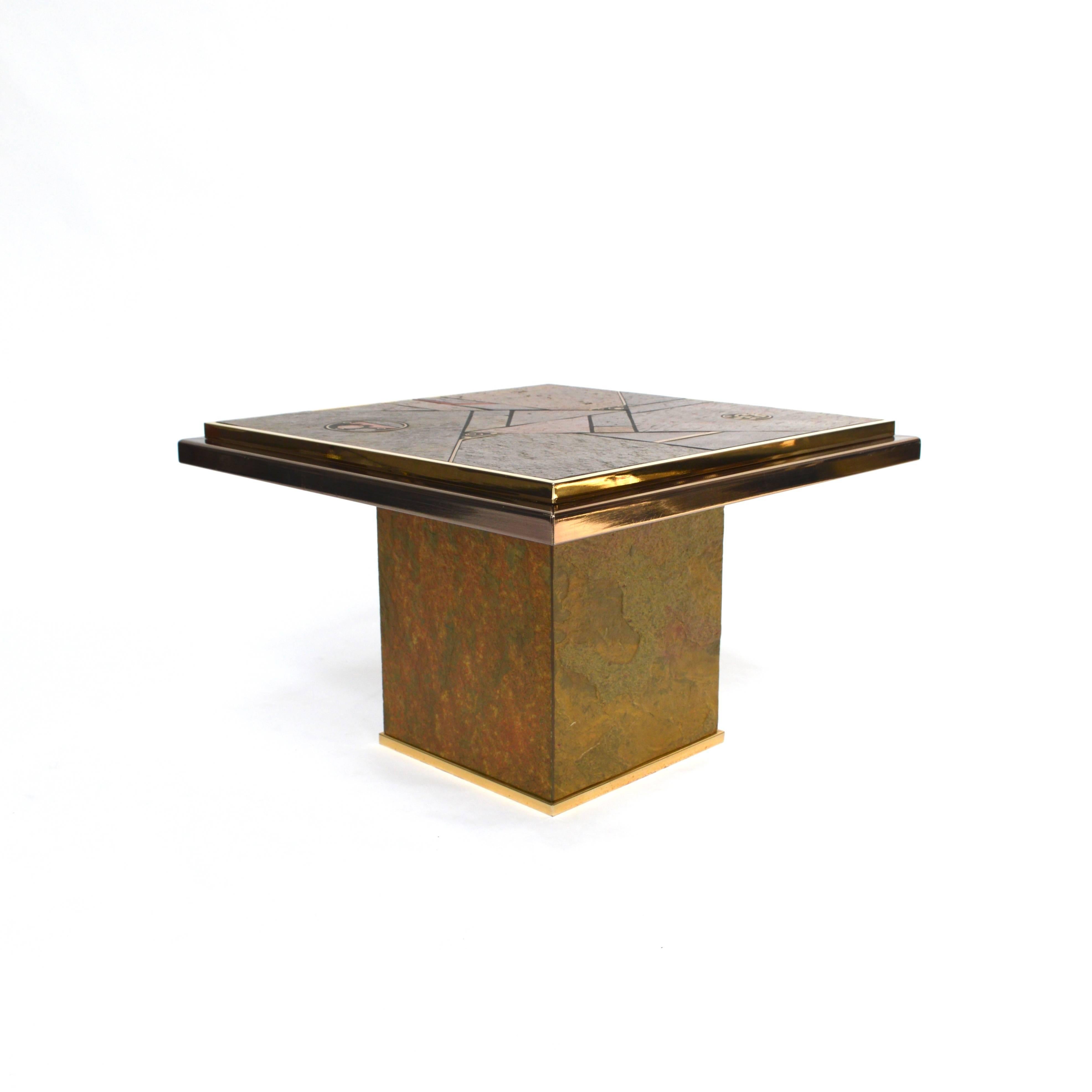 Brutalist side or coffee table in the style of Paul Kingma and manufactured by Fedam. It has a beautiful slate stone and brass mosaic top and brass edges. The sides of the base are also covered with slate.
In very good to excellent condition. A