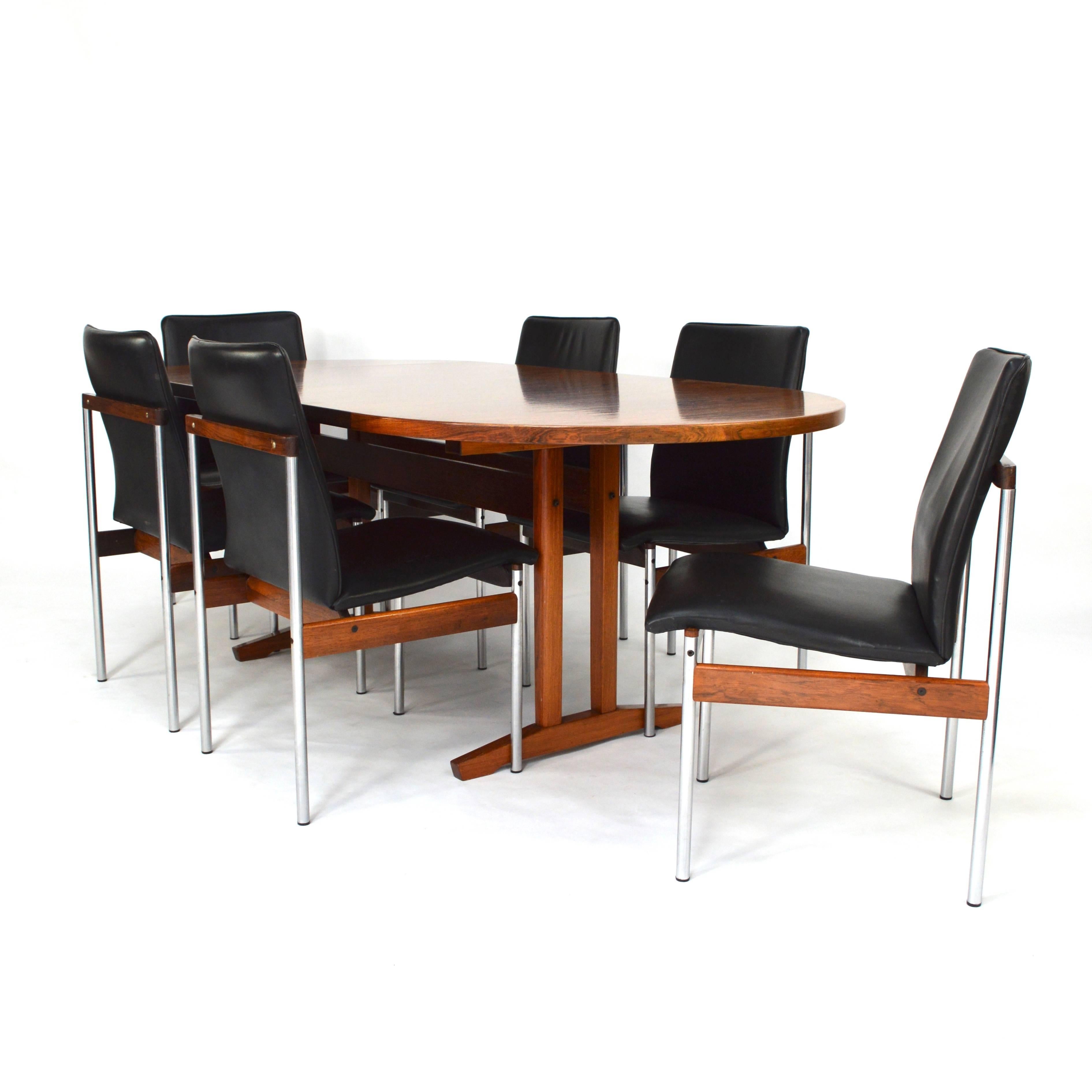 Set of six dining chairs by Thereca.
Design after Inger Klingerberg.
Made of solid Brazilian rosewood, black leather and chrome.
Also available with the dining table.
In very good condition.
We offer very competitive shipping prices.