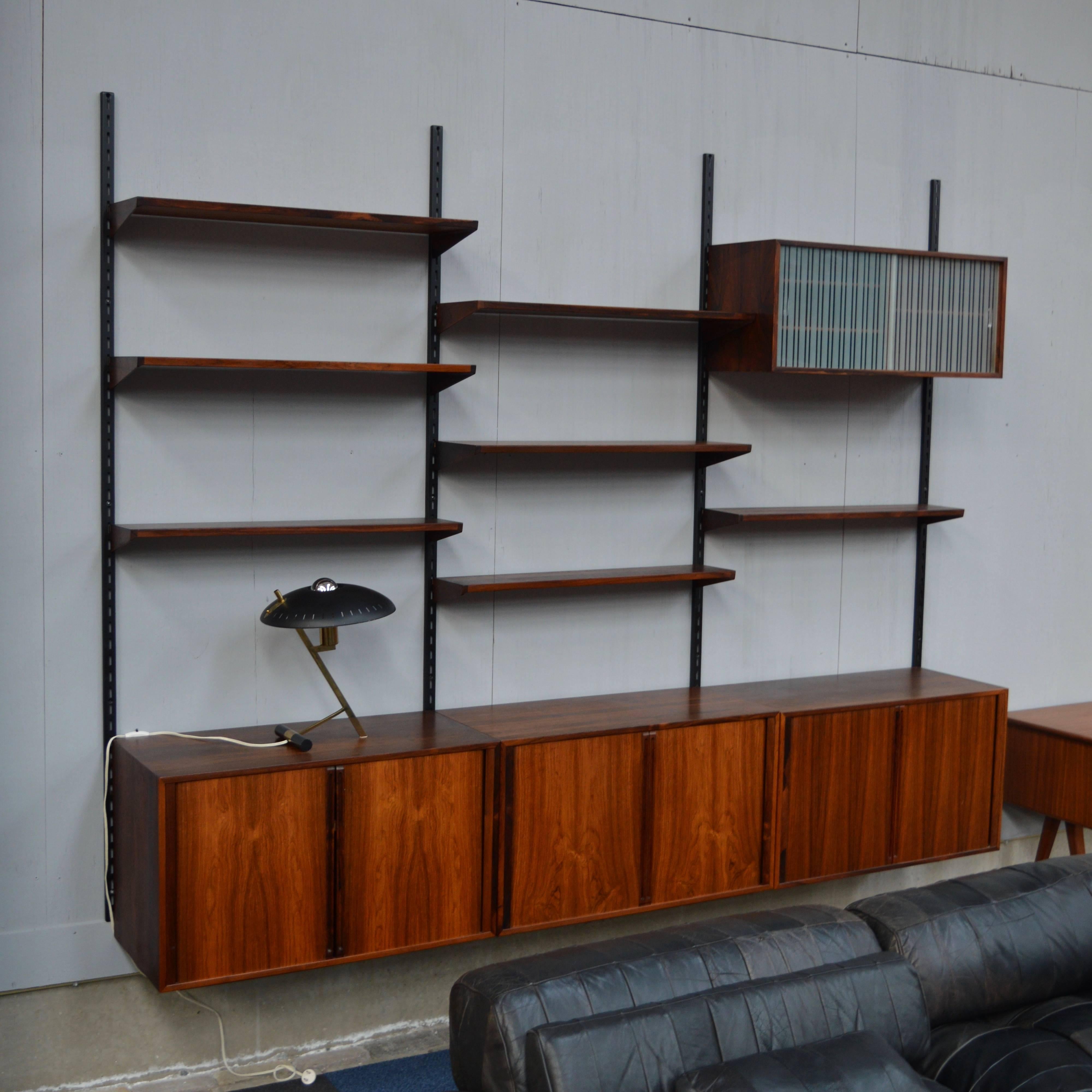 Brazilian rosewood wall unit by Kai Kristiansen for FM Møbler, Denmark.
The cabinets have sliding doors wich are made of highly crafted lamellae that turn inside.
Inside two of the cabinets there are two birchwood drawers lined with green