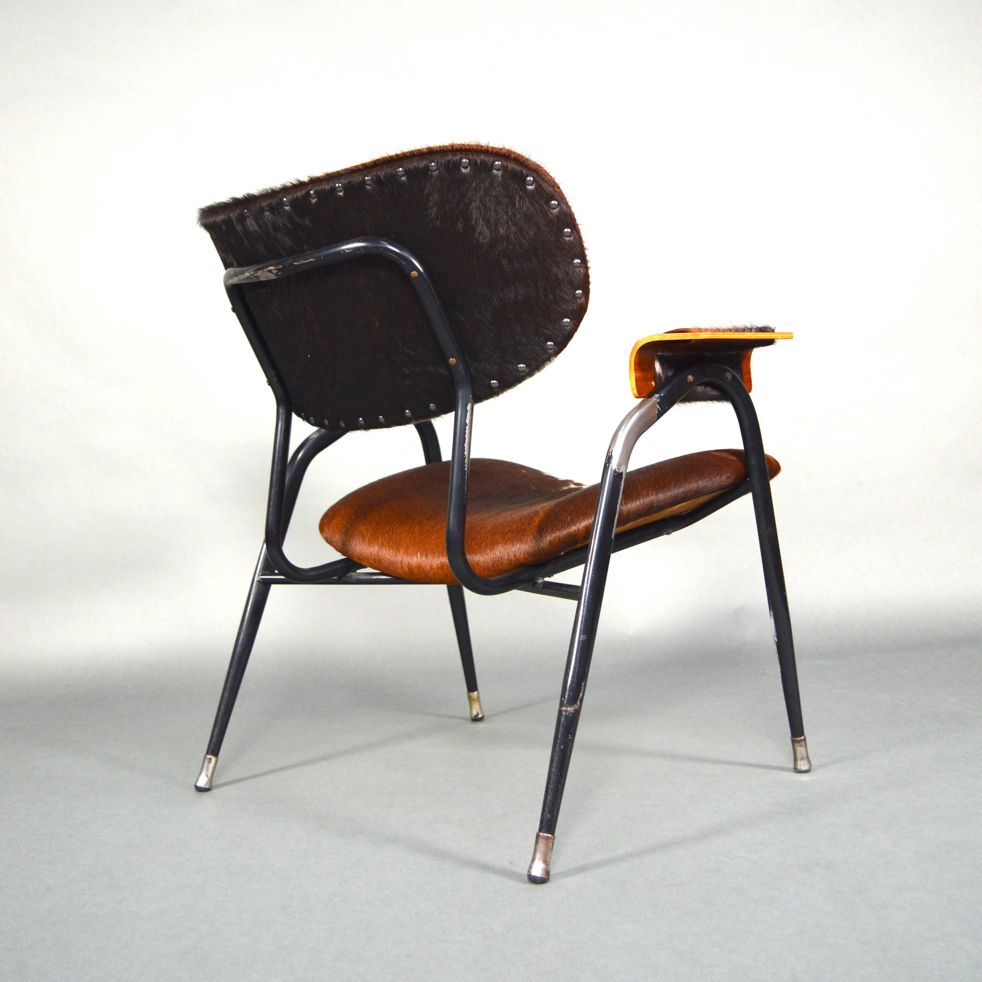 Rare model lounge chair by Gastone Rinaldi that has been reupholstered with a beautiful Cowhide leather.
The black lacquered metal base has signs of wear to the lacquer. 
