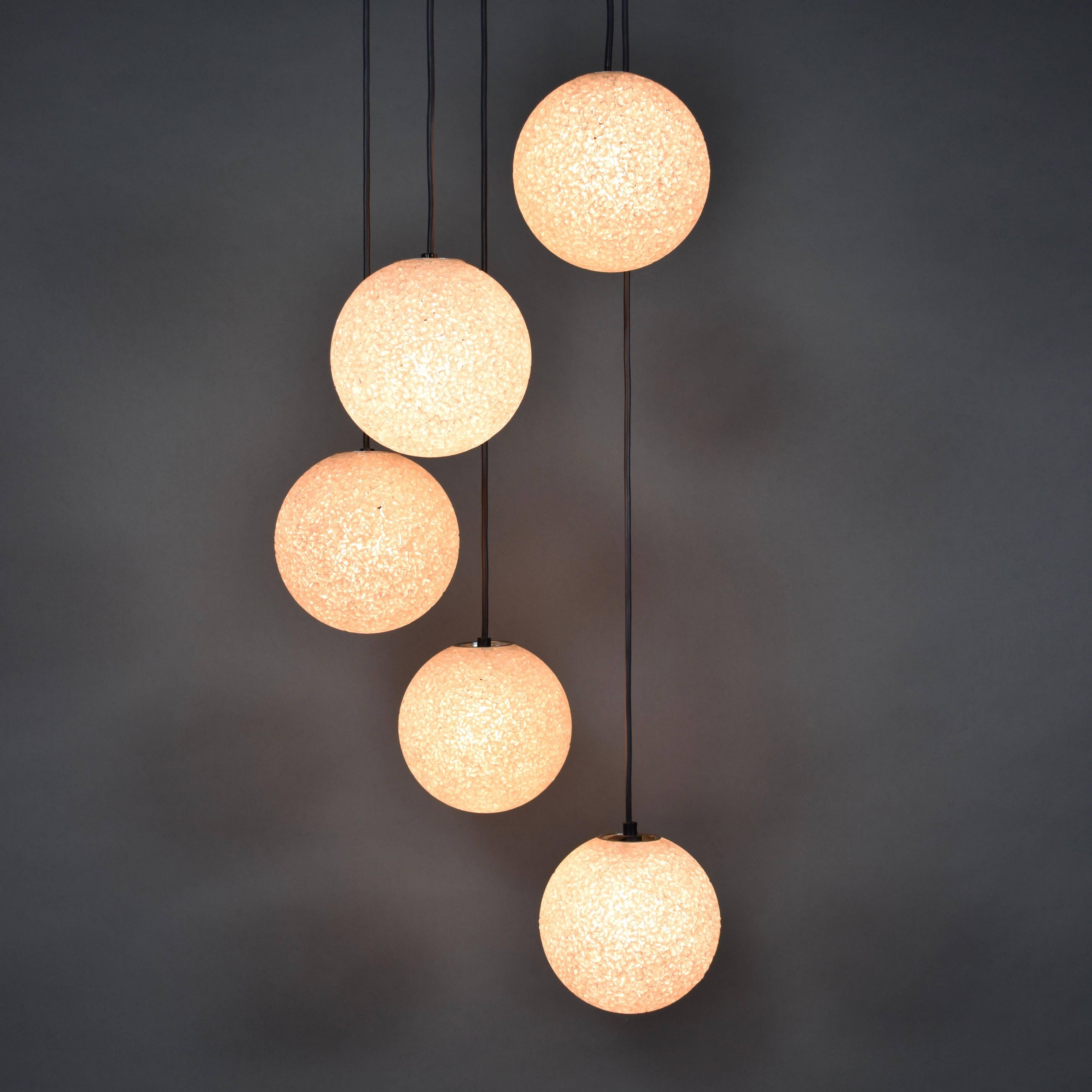 Stunning five-globe chandelier, 1960s. The globes are made of organic shaped pieces of plexiglass and give an amazing star-like light effect.

Designer: Unknown

Manufacturer: Unknown (maybe RAAK Amsterdam)

Country: Netherlands

Model: