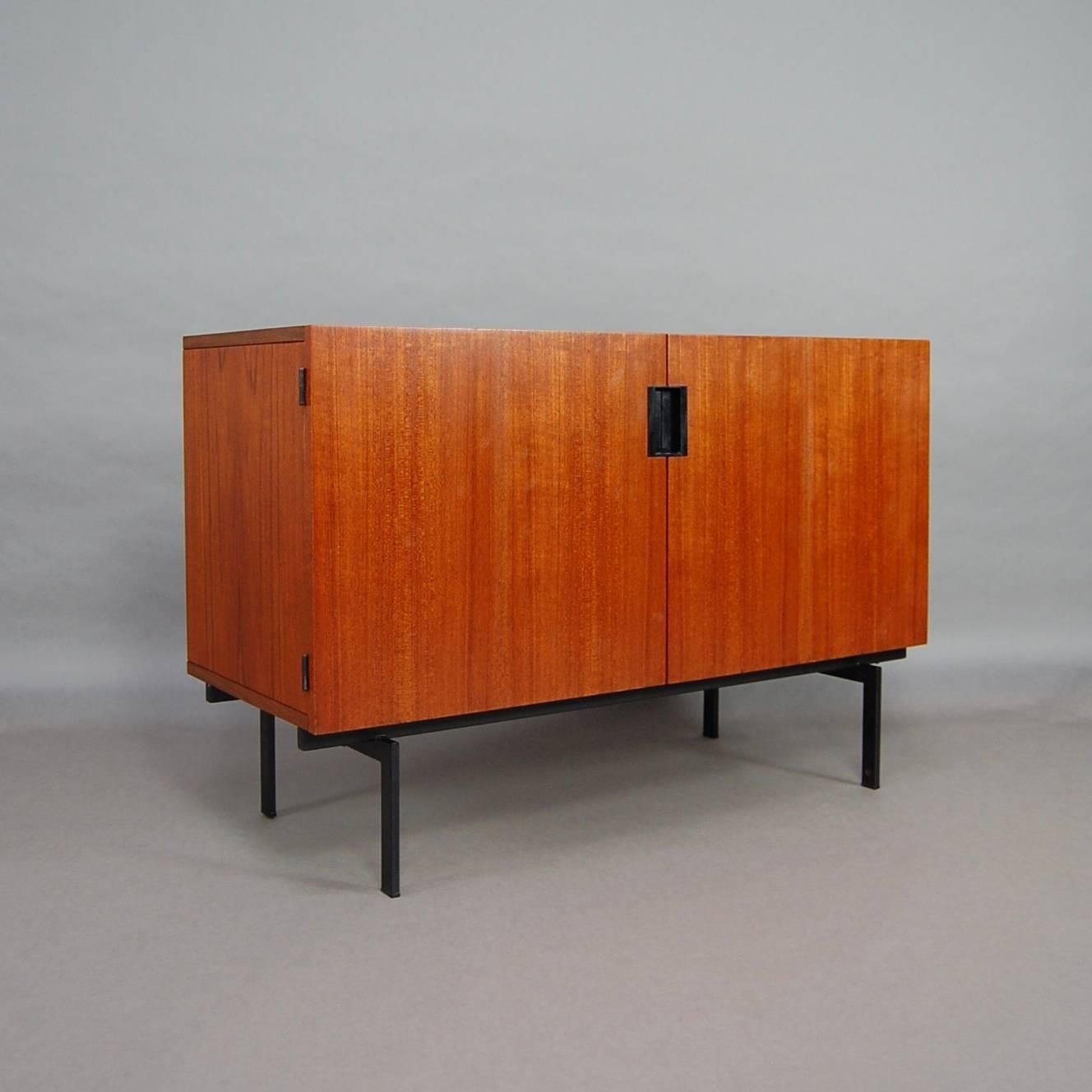 This very nice small sideboard was designed by Cees Braakman in 1958 for Pastoe. It is made of teak veneer and is in very good condition (only a superficial scratch on top).
The base is made of black lacquered metal.
It still has the Pastoe label.