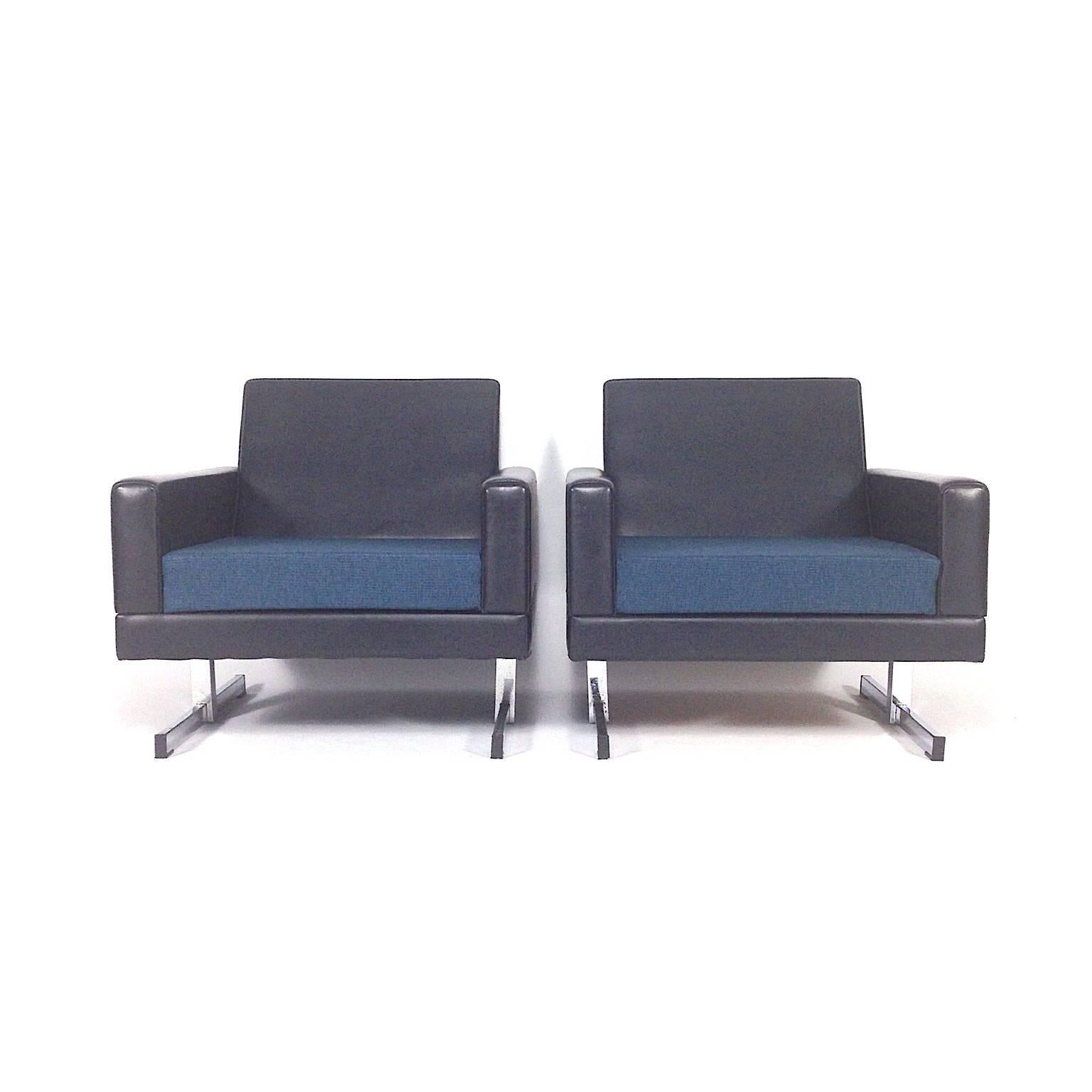 Pair of midcentury Dutch or German design club lounge chairs with new fabric cushions. 
They are made black faux leather and chromed metal feet.