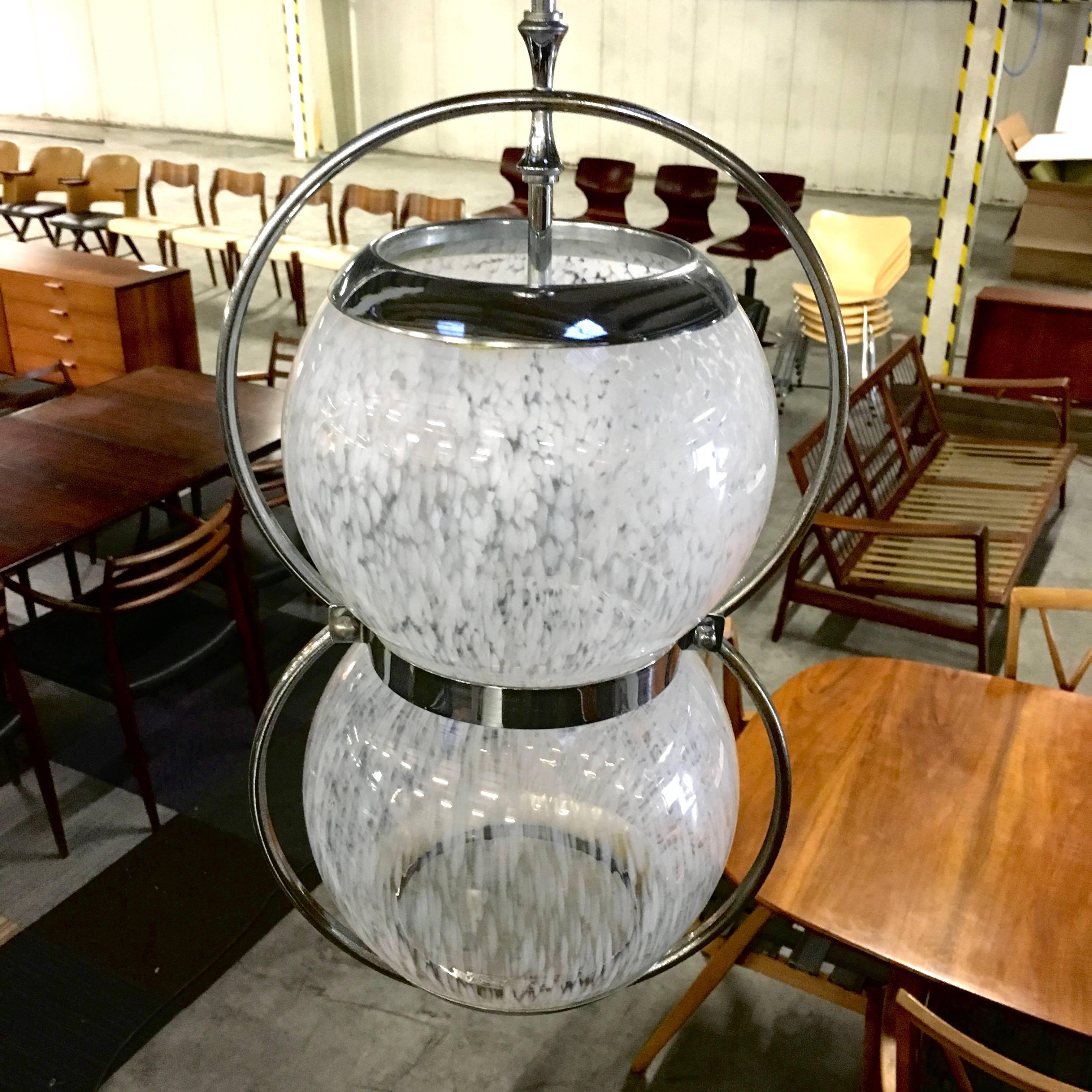 Beautiful pair of Italian blown Murano glass pendant lamps with chrome-plated metal. It may be Murano or in the style of but that they are very rare is certain. The glass is semi-see through and has milky white striped spots. Both the glass and the