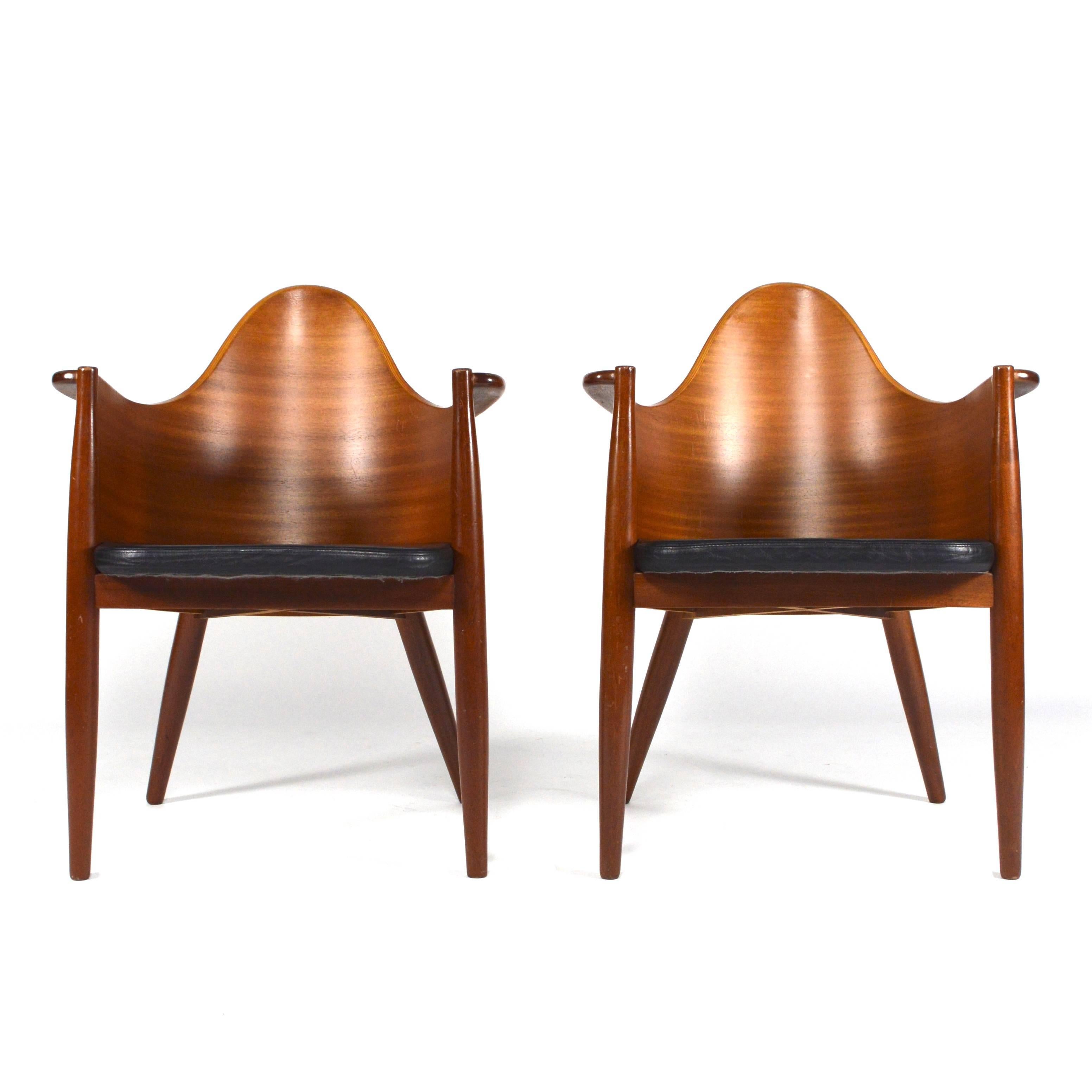 Very unique and absolutely gorgeous set of Teak plywood side / dining chairs from the 1950-60's.
Solid Teak legs and armrests with a beautiful plywood back.
The chairs are in good condition with normal age related signs of use and still with it's