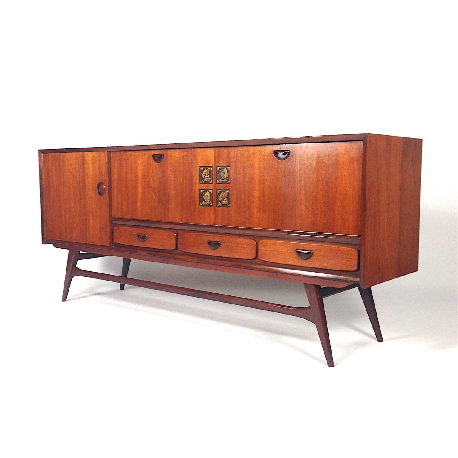 Elegant sideboard by Louis van Teeffelen for Walraven & Bevers - The Netherlands, 1960's.
Made of beautiful warm colored Teak with ceramic art inlay by artist Jaap Ravelli.
Van Teeffelen also designed absolutely gorgeous wall units, tables and