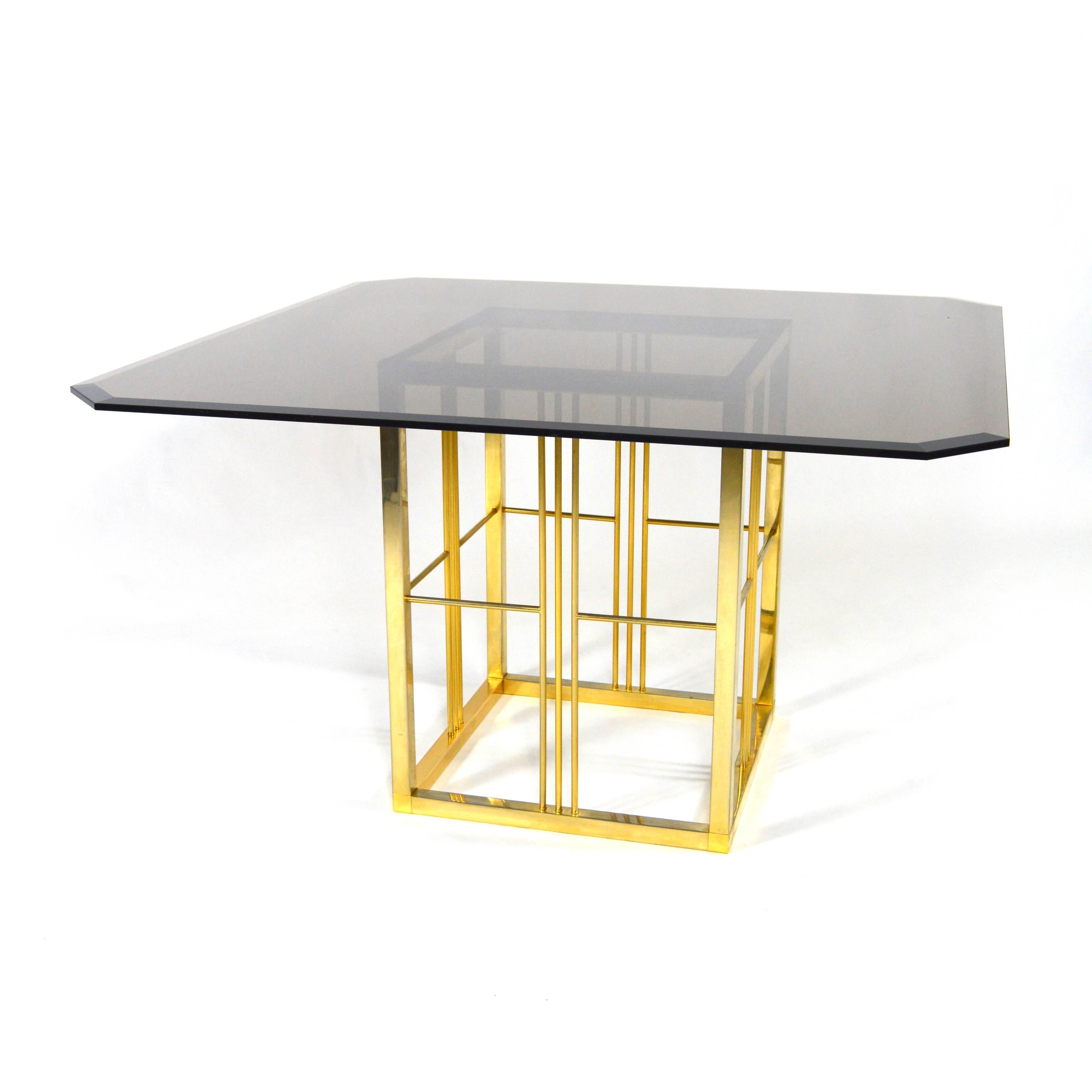 Brass and glass dining table in the style of Pierre Cardin. Beautiful gold brassed base and a smoked glass top of heavy quality with cut corners.
The table is probably of French or Italian origin.
In very good condition with some normal age and
