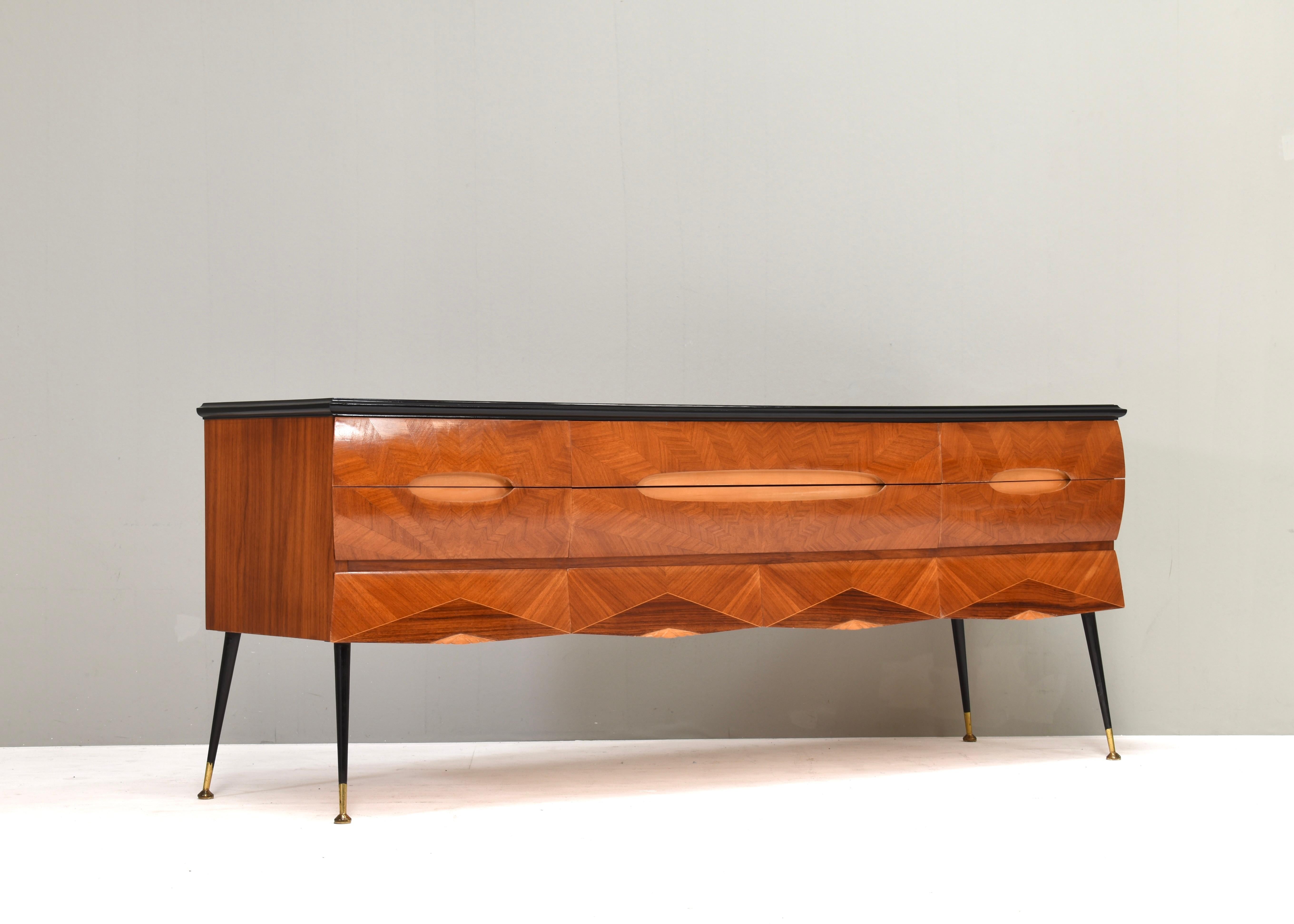 Mid-Century Italian Sculptural Sideboard in Walnut – Attributed to Dassi, 1950s
10 drawers
Refinished black edge and new glass top!

Elevate your interior with this rare and elegant mid-century Italian sideboard, a masterful example of 1950s design