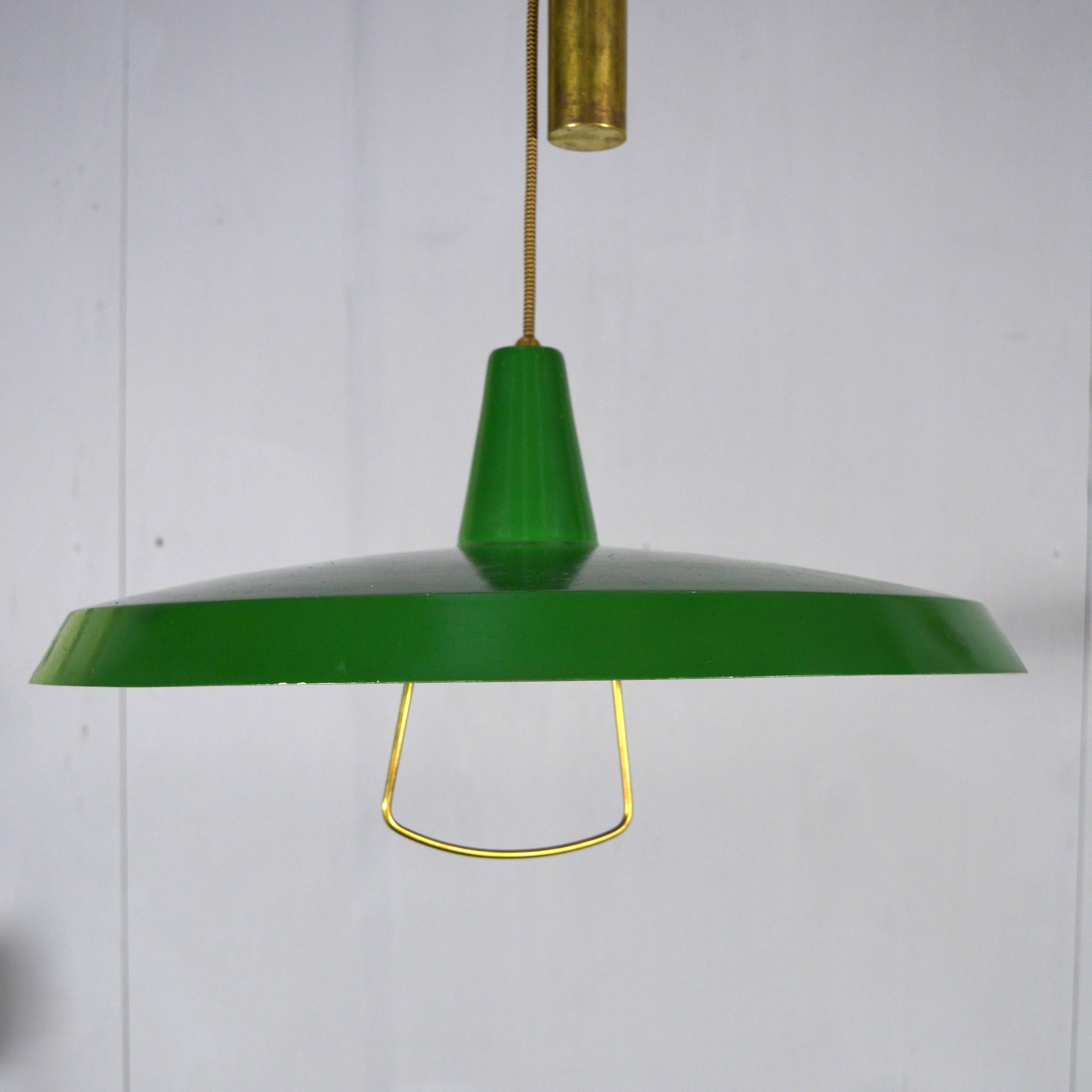 Gorgeous counter balance pendant lamp with brass counterweight and other brass details.
Green enabled metal lampshade.
The lamp has new wiring. Just attach an US or other socket plug and it is ready to go.
E26 bulb socket.


