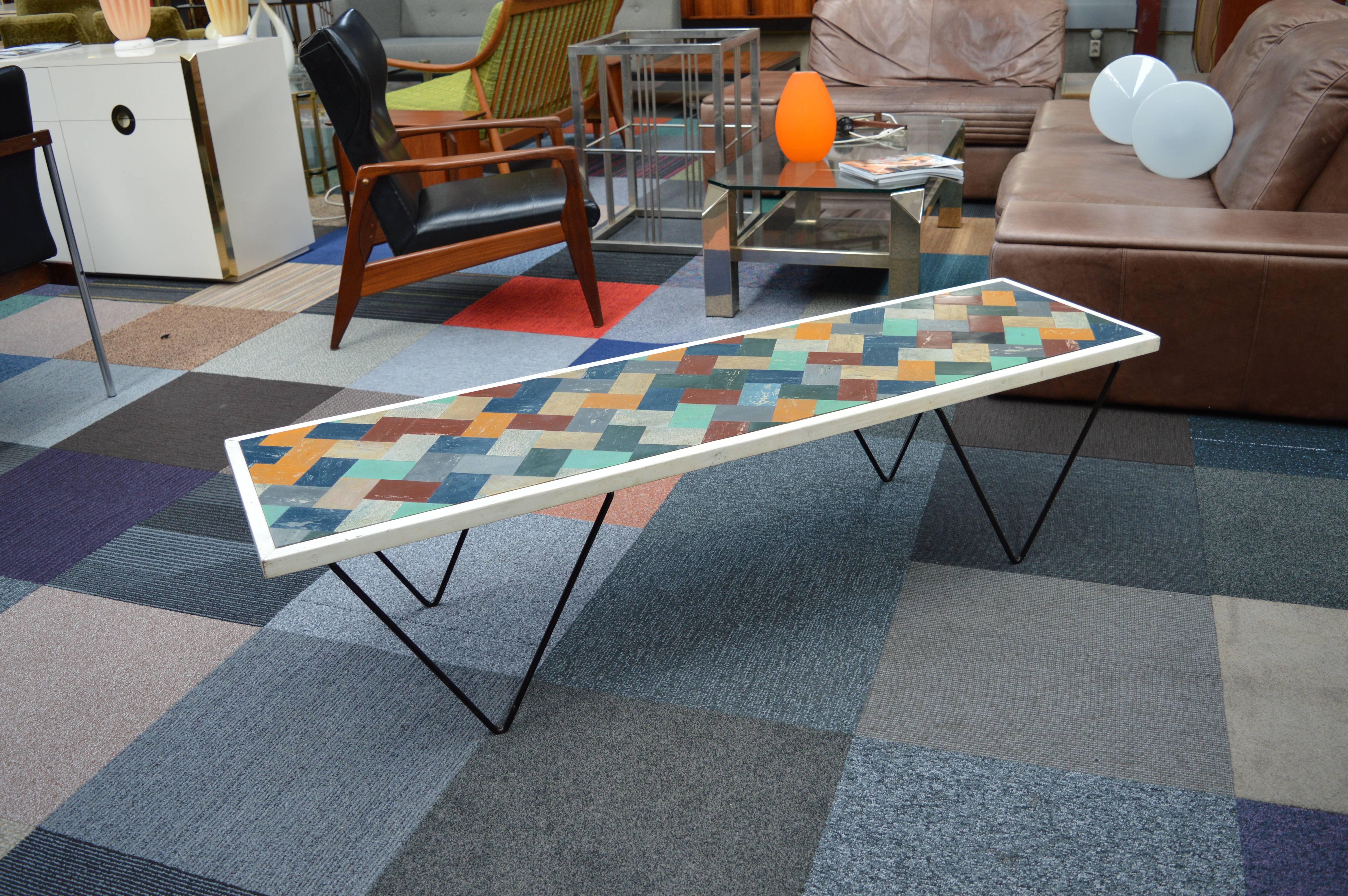 Mid-Century coffee table with Mozaik Linoleum top, lacquered wood edging and V-shaped lacquered metal legs. 
The table is in good condition. It has a patinated vintage look with signs of use and age.



    