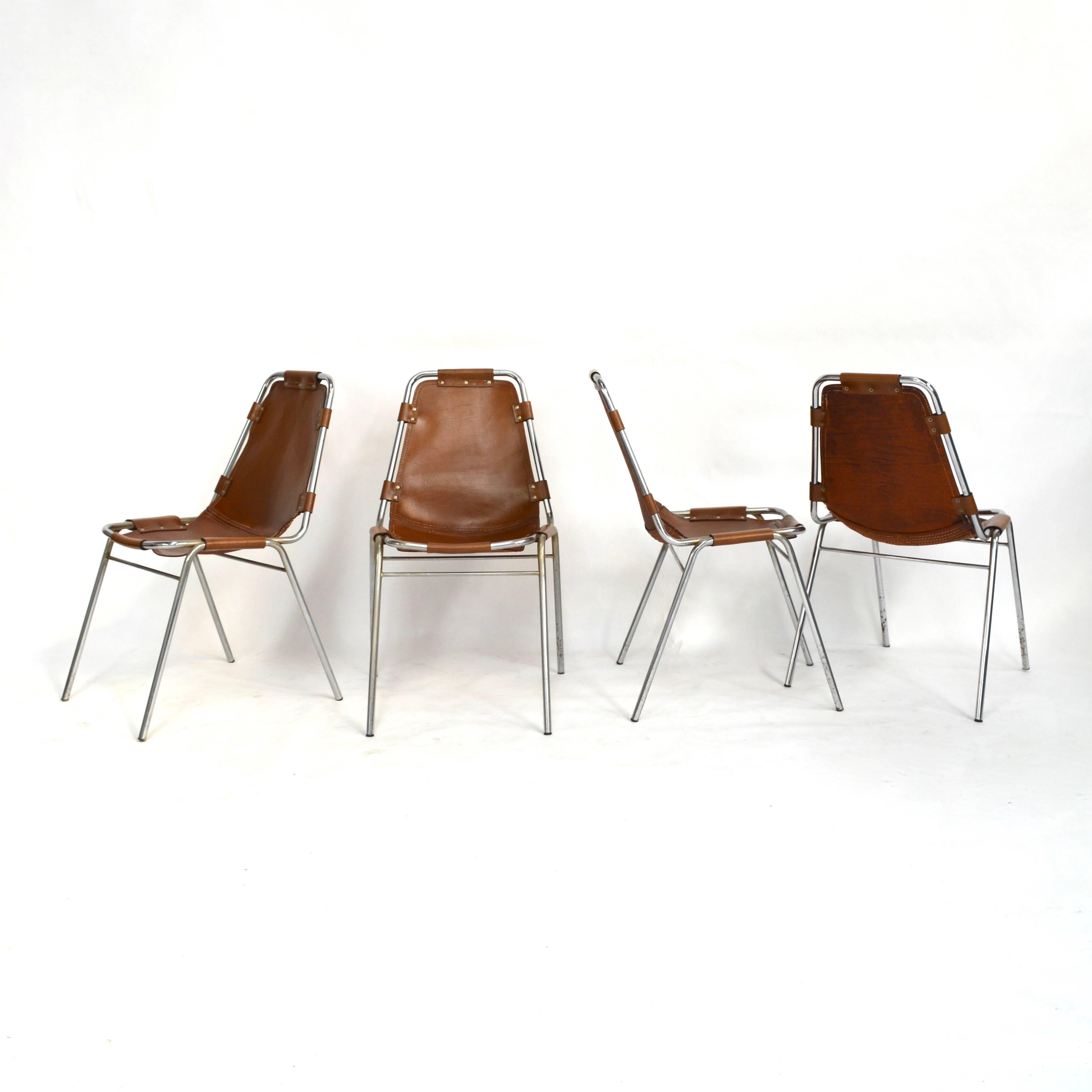 Set of four original 'Les Arcs' chairs by Charlotte Perriand from 1973.
Chrome tubular base with cognac saddle leather.
Overall very nice patina.
Stamped 14 MAR. 1973.

Date of design: 1950s

Date of manufacture: 1973 (the leather has dates