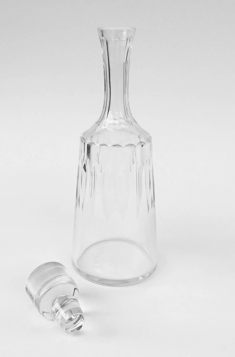 French Baccarat D'Assas pattern cut crystal decanter and stopper, the flaring-cylindrical body of the decanter with panel-cut neck and vertical cuts on the upper portion of the bottle, the base also cut. Etched to the underside with Baccarat France,