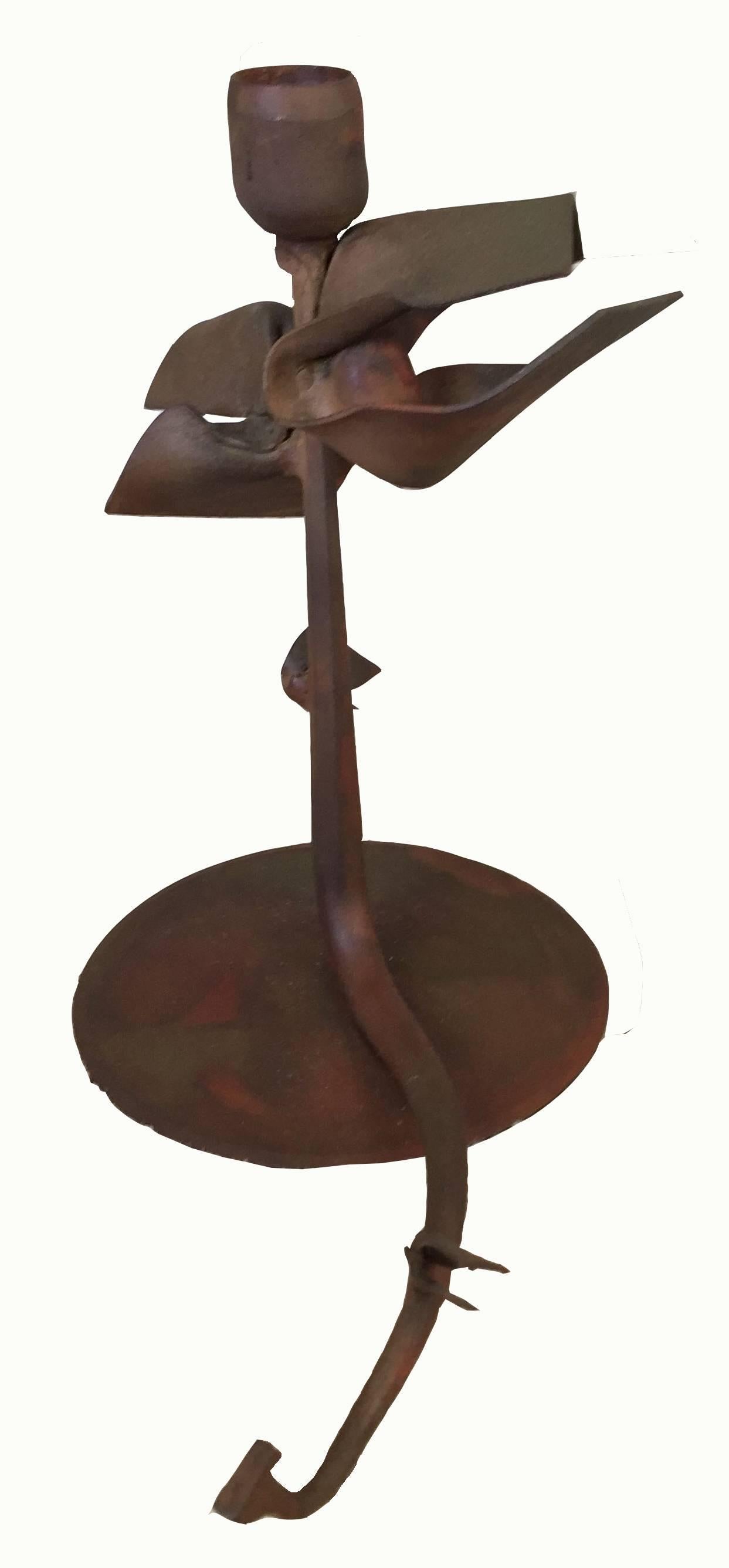 Albert Paley forged iron floral candlestick, with trailing stem off to one side of the cylindrical base. 

Signed Albert Paley 1993 to the base. 

Measures: 9